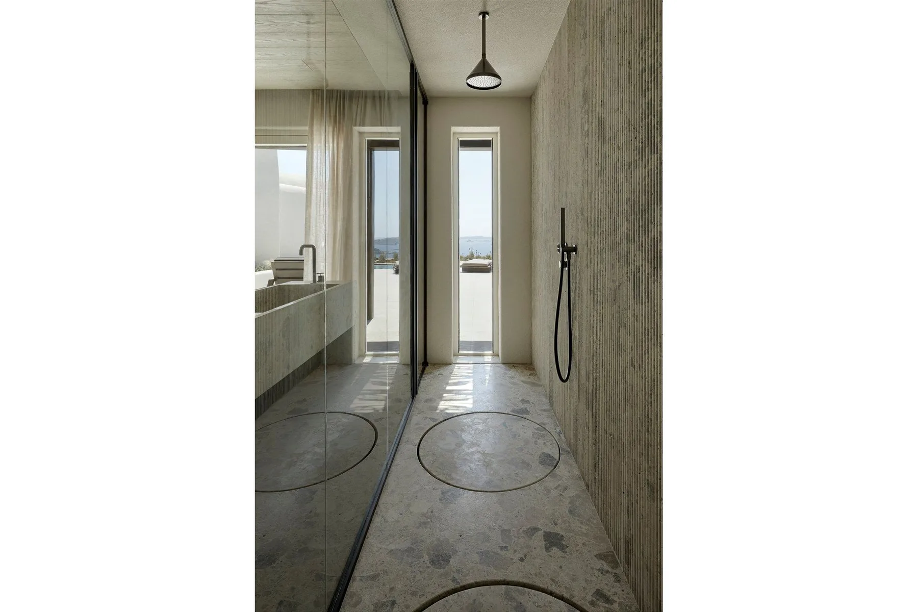 A narrow bathroom with a wall-mounted shower and a tall window.