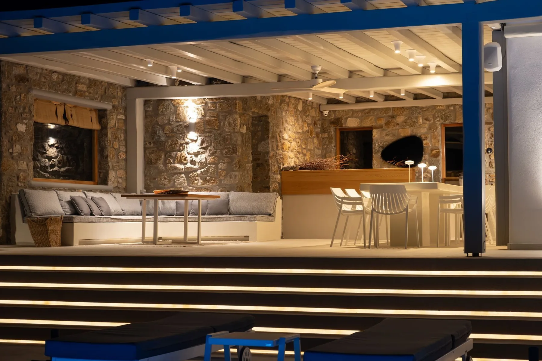 A stone-walled lounge and bar area with seating beneath exposed ceiling beams.
