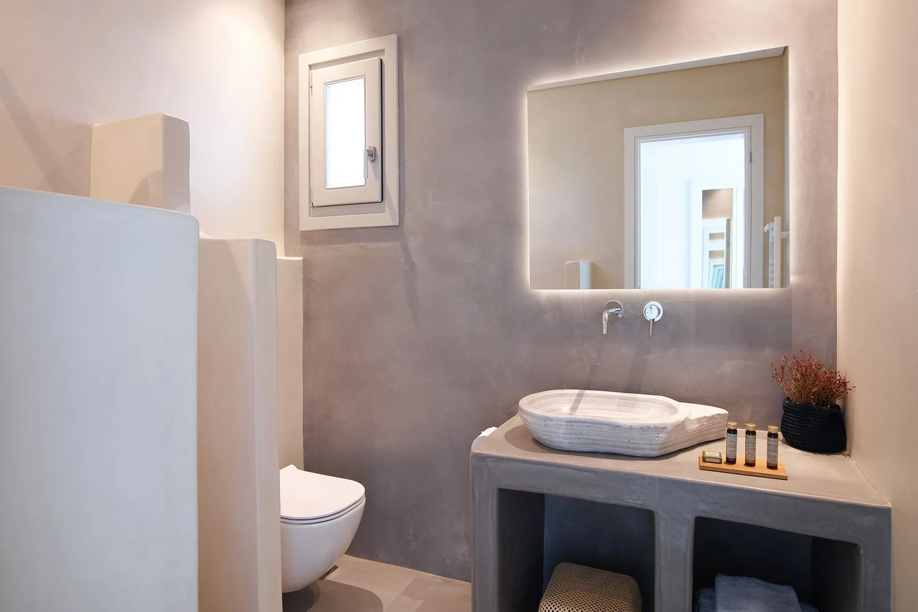 A bathroom vanity with a vessel sink and a large mirror.