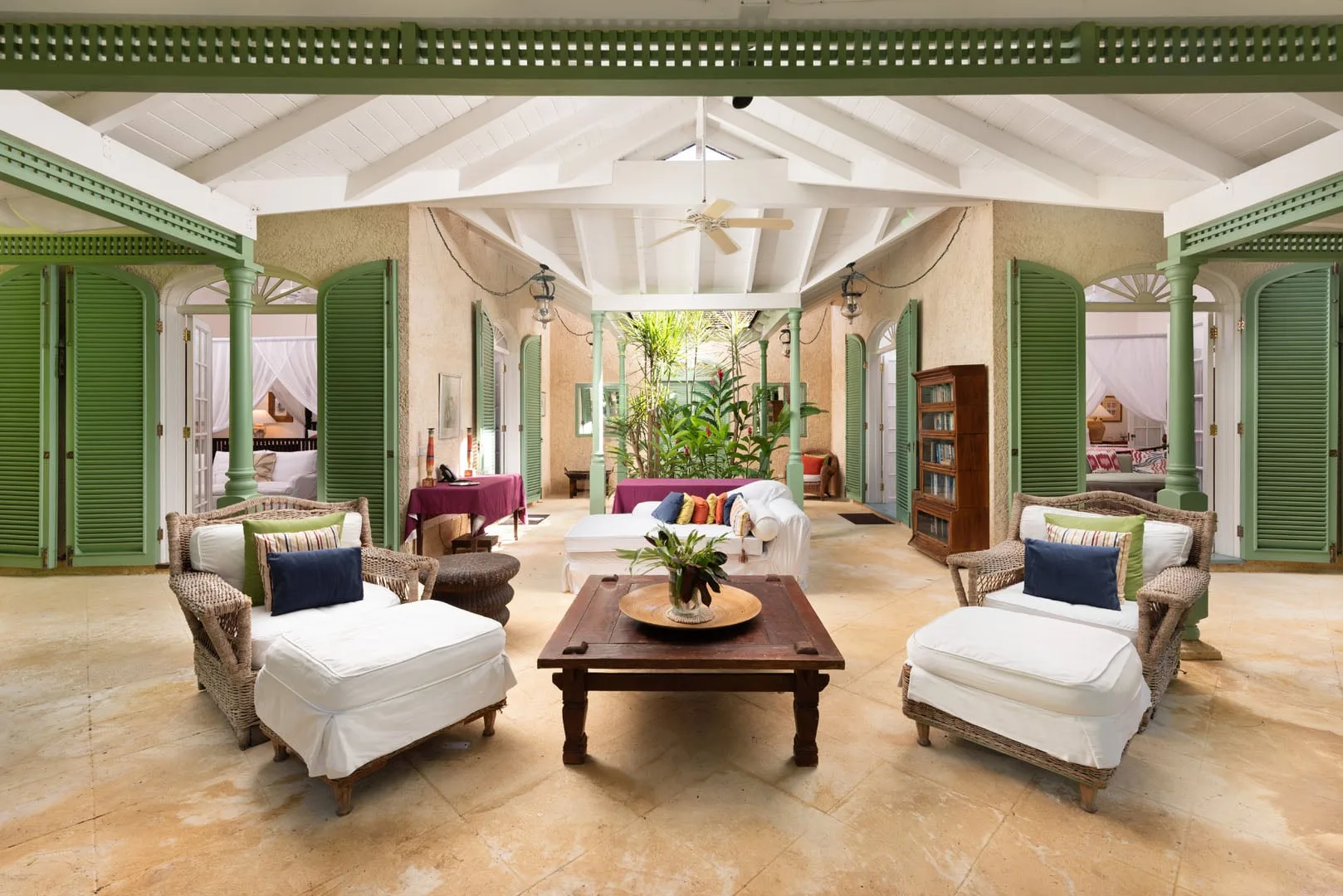 A bright living room with seating arranged around a wooden coffee table.