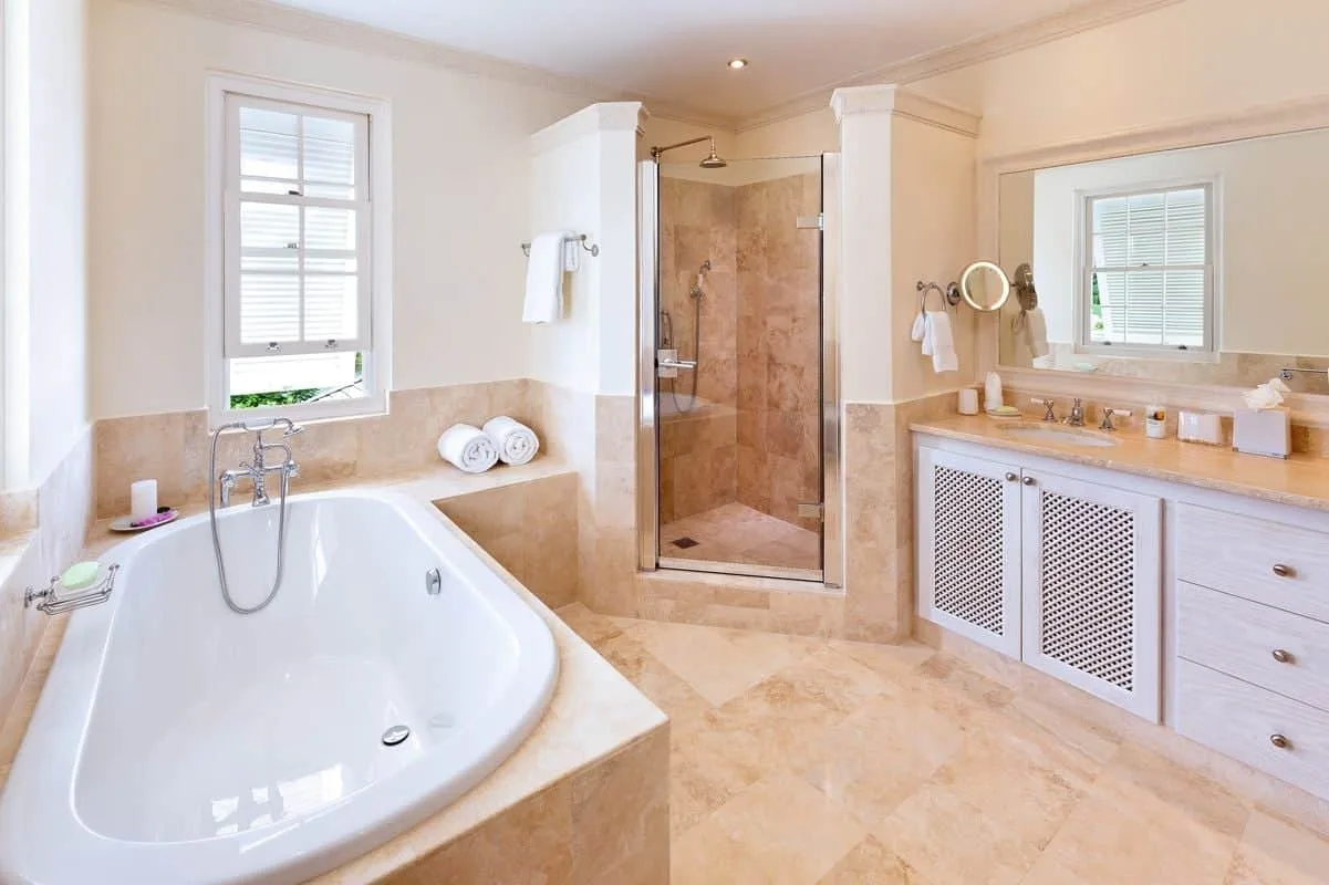 Un baño con bañera, ducha de cristal y tocador.
