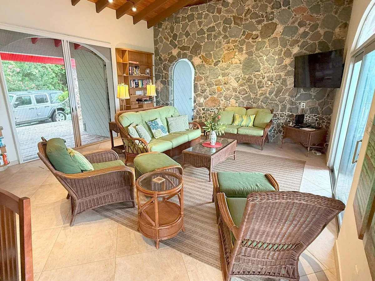 A living room with wicker seating arranged around a low coffee table.