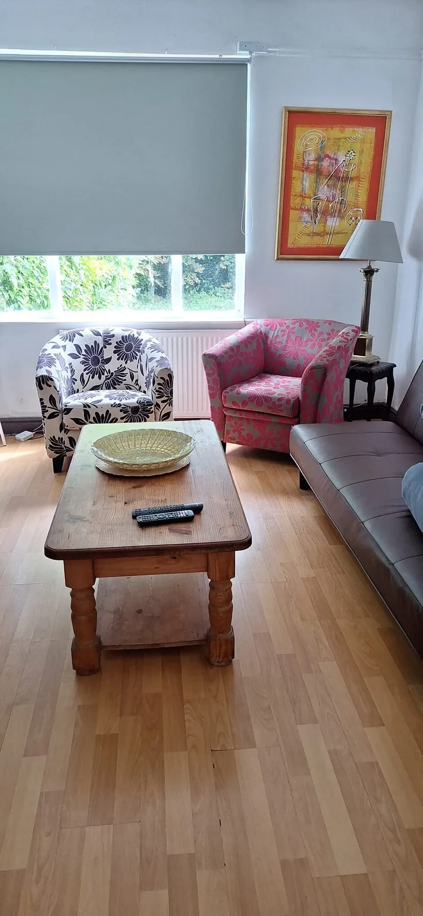 A living room with seating arranged around a wooden coffee table.