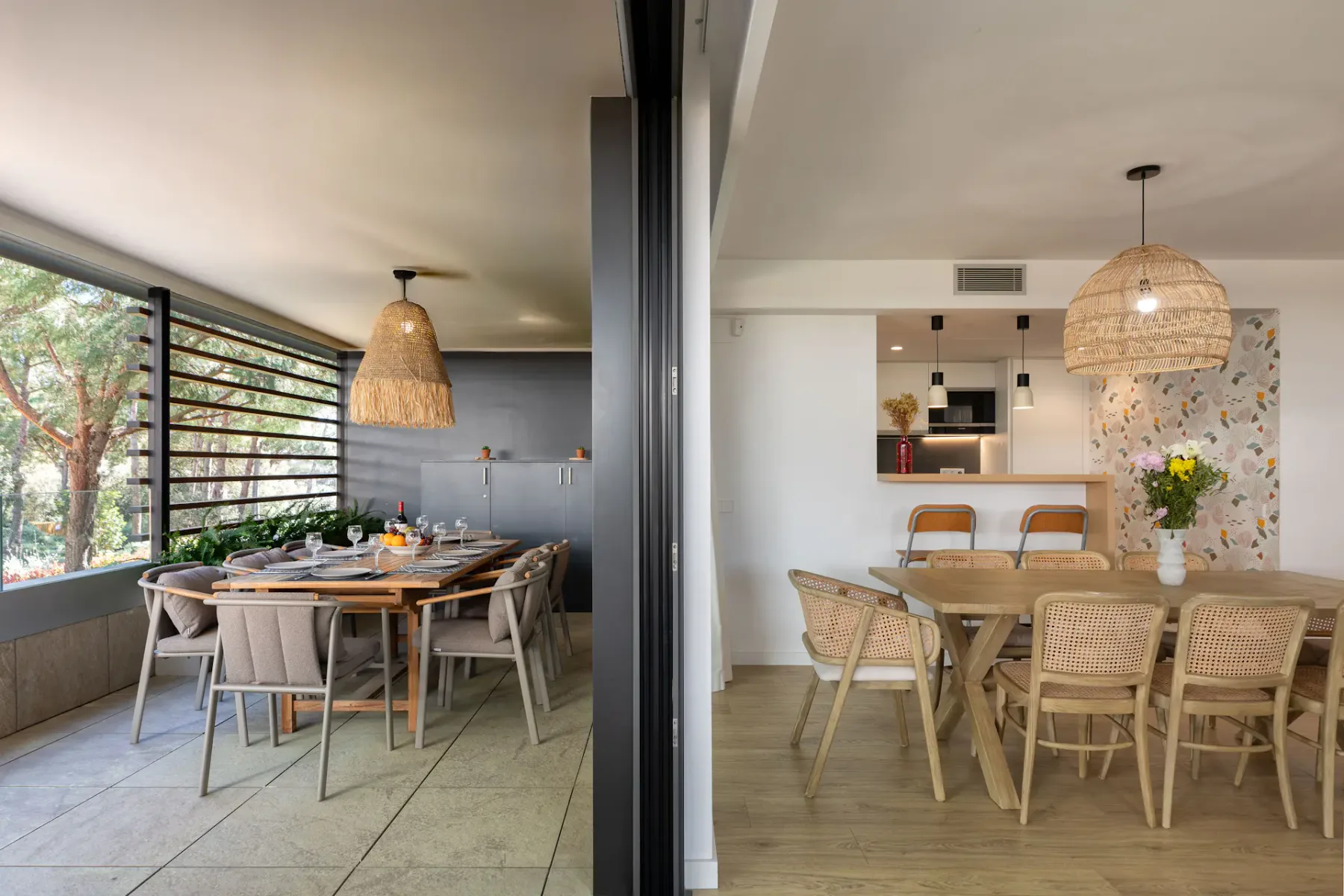 A dining area with wooden tables, woven chairs, and hanging pendant lights.