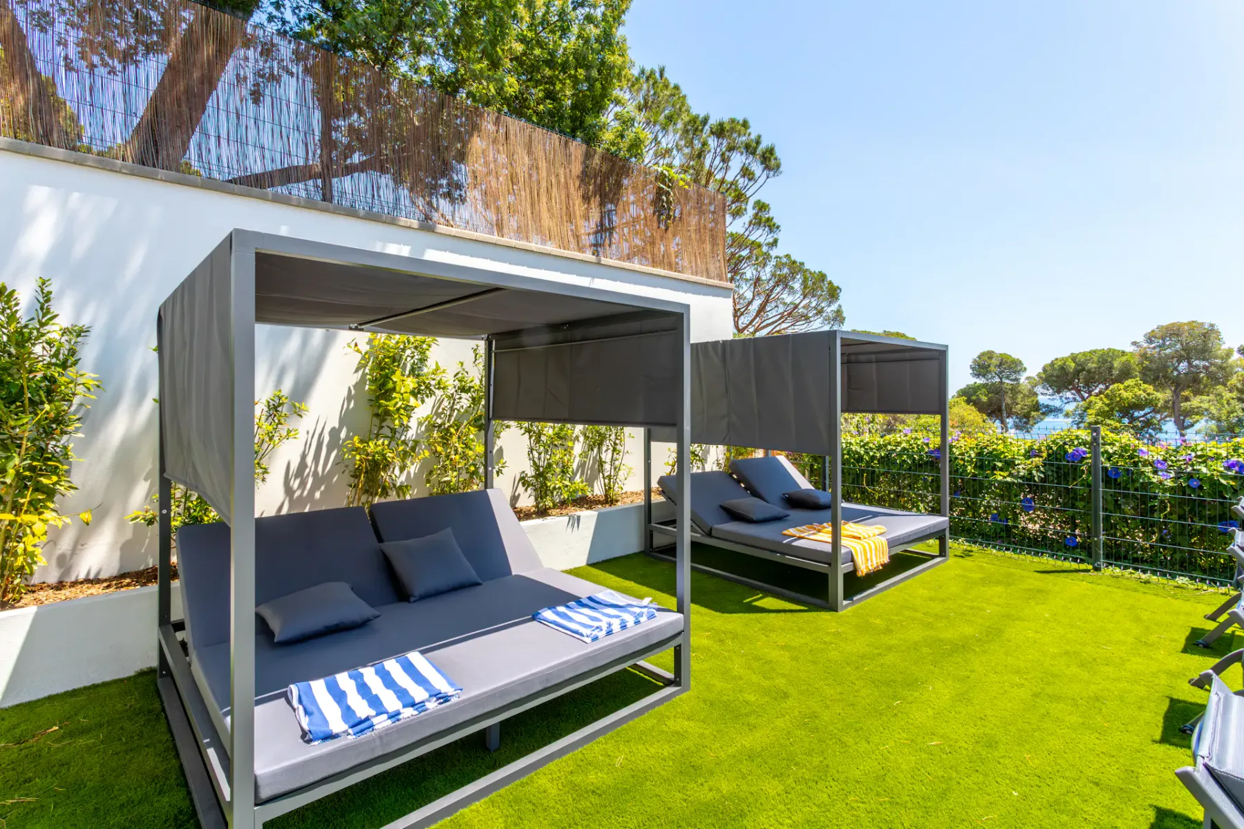 Shared amenity: Outdoor lounge area with shaded seating on a grassy lawn.