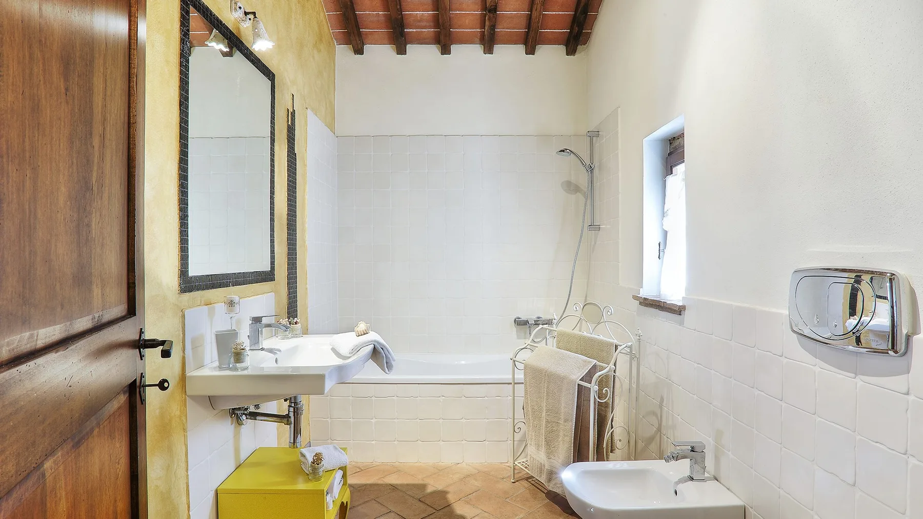 A bathroom with a bathtub, sink, and shower.