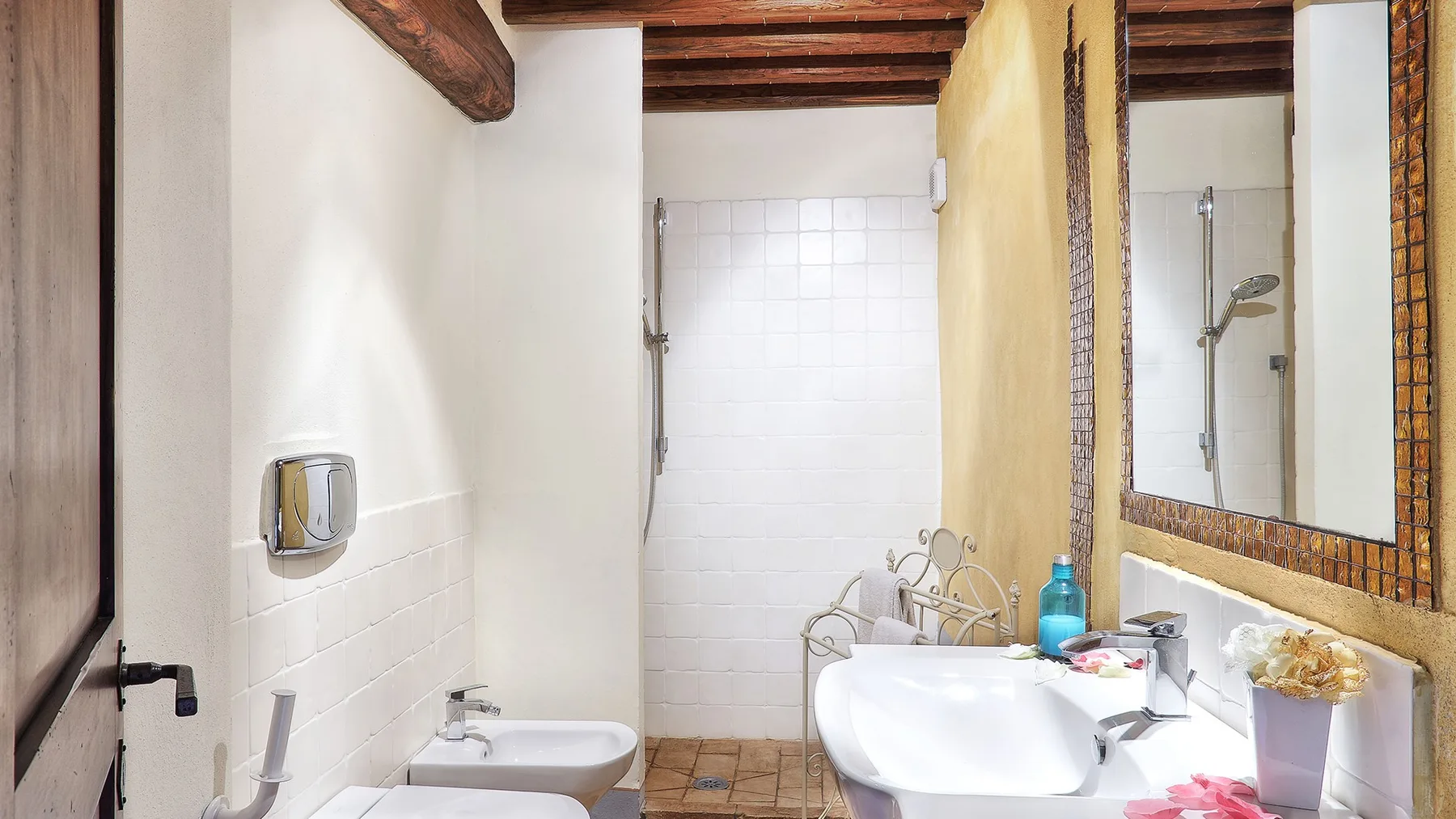 A bathroom with a bathtub, sink, and shower.