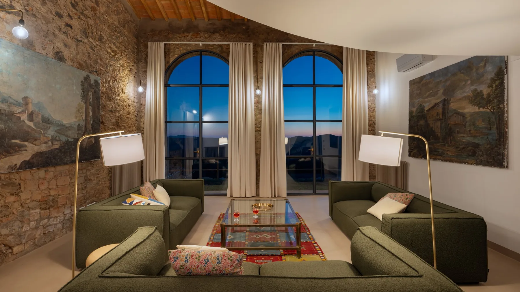 A living room with seating arranged around a glass coffee table.