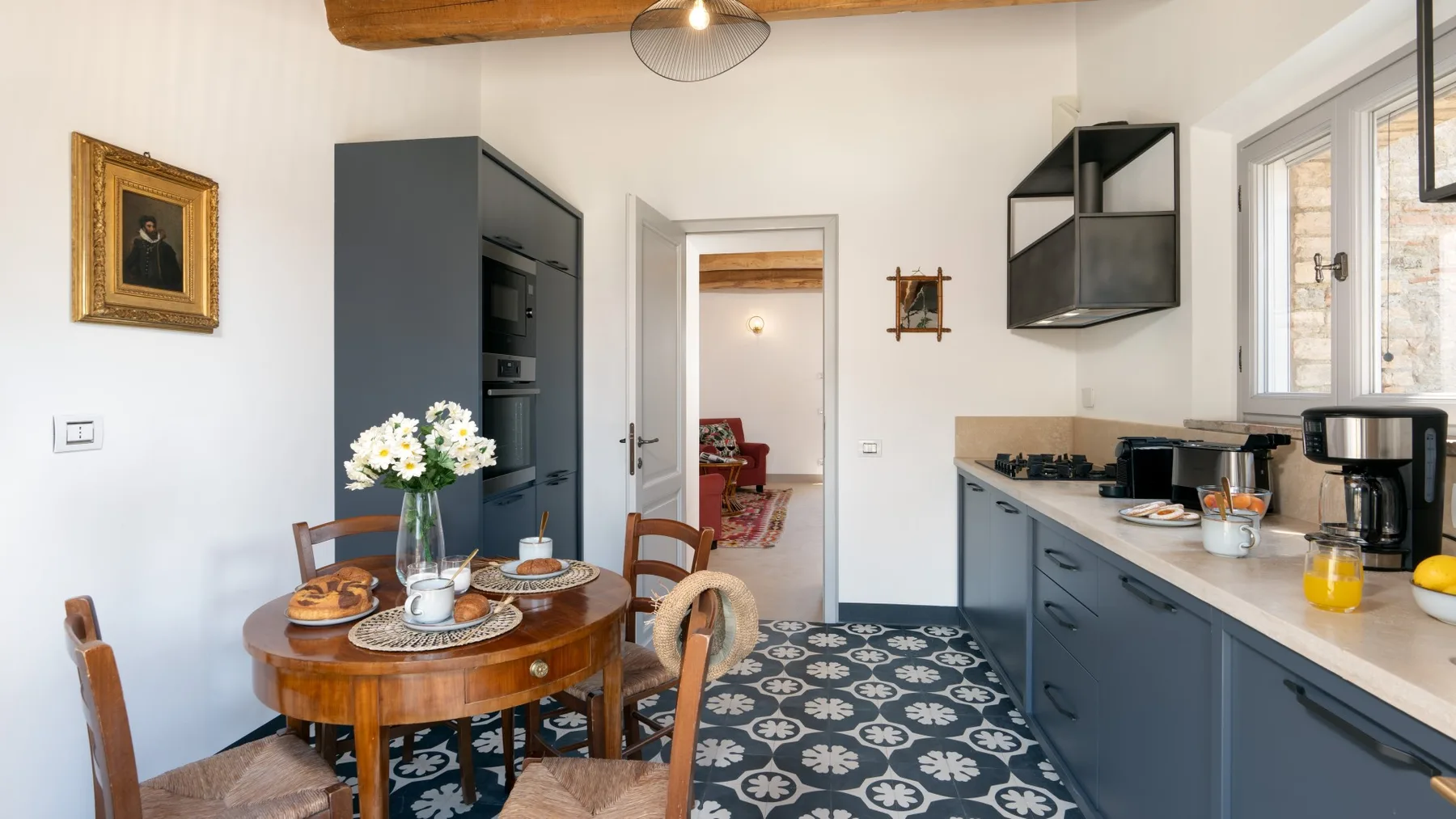 A dining area with a round table beside a kitchen counter.
