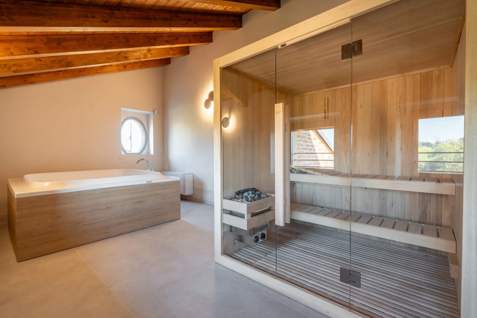 A wood-paneled sauna with tiered seating and a glass front.