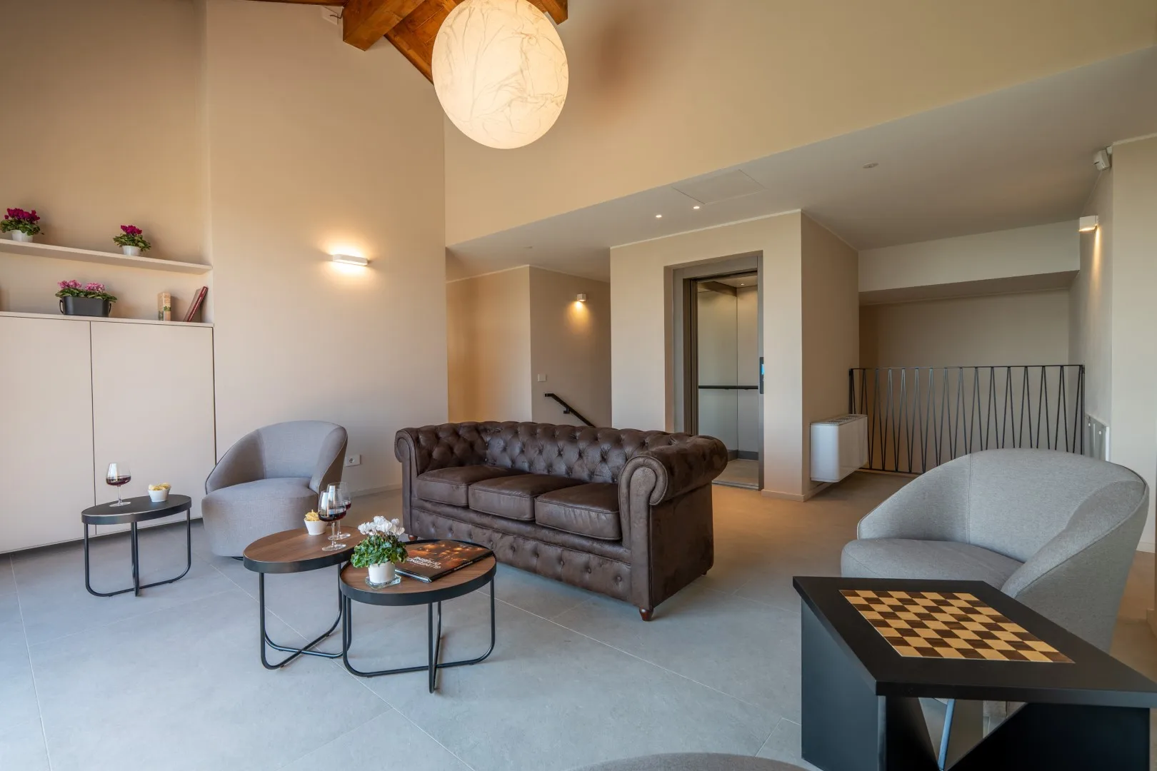 A living room with seating, coffee tables, and a chessboard.