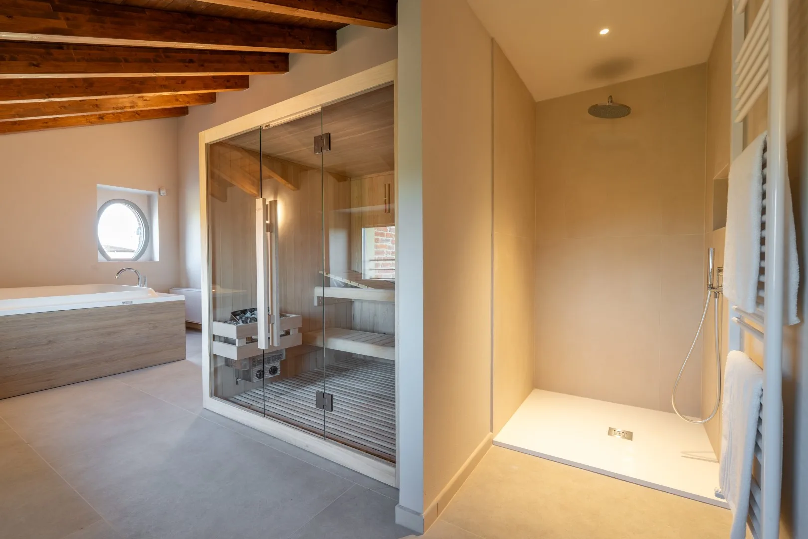A bathroom with a bathtub, glass shower enclosure, and overhead showerhead.
