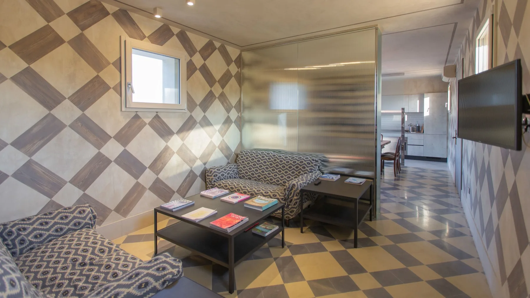 A tiled sitting area with patterned seating and a low table.