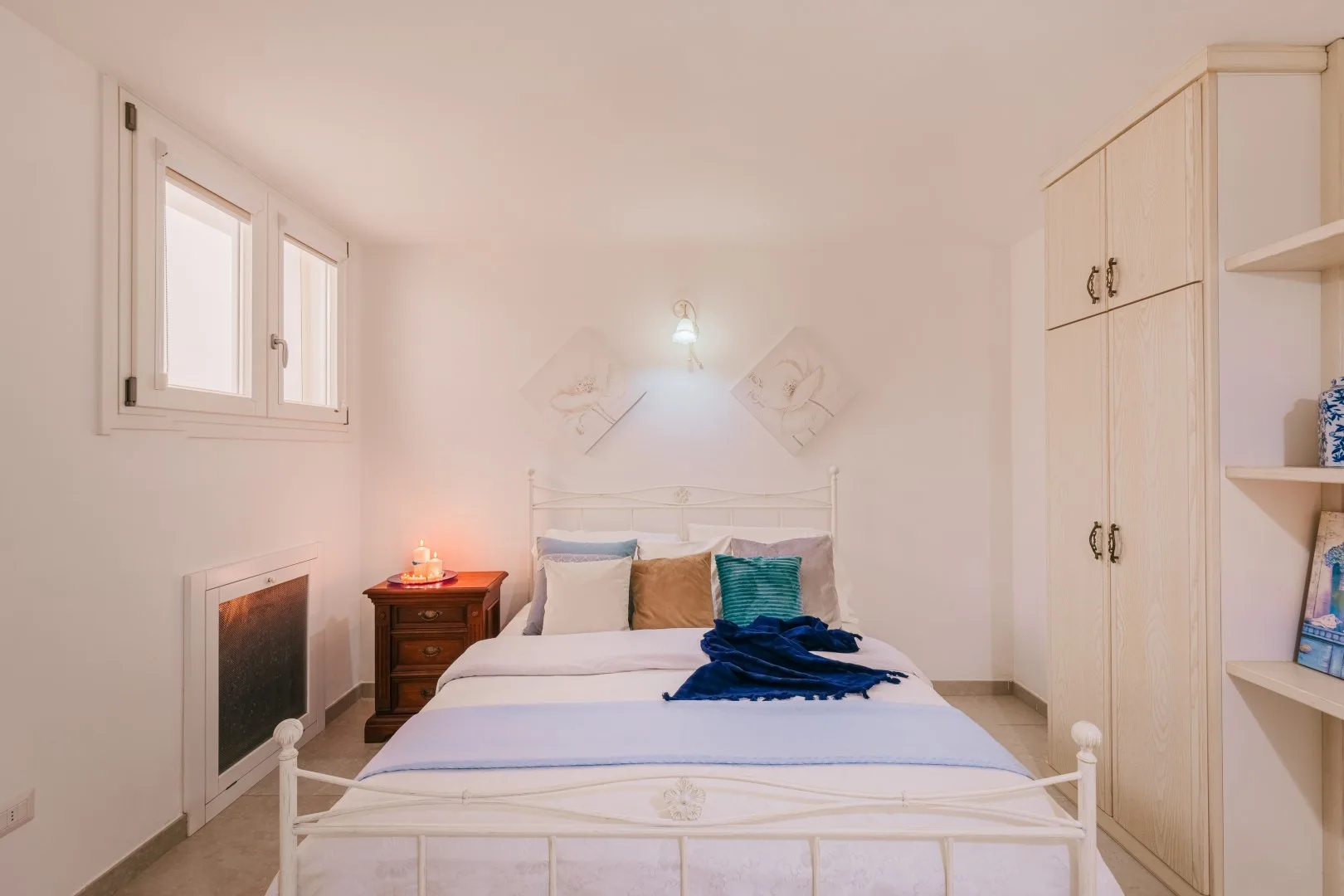 Un dormitorio con una cama, una mesita de noche y armarios empotrados.