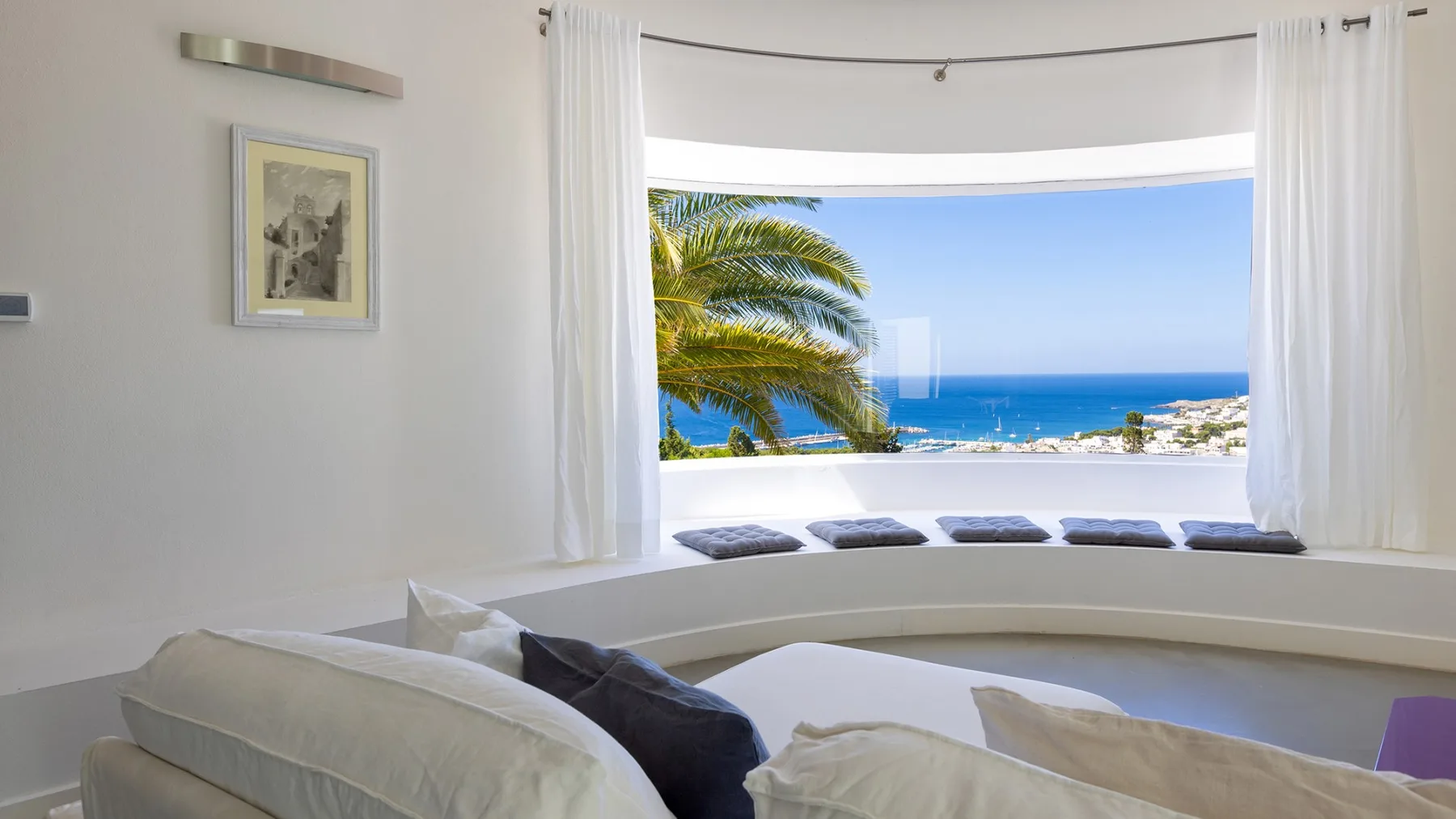 Una luminosa zona de estar ofrece vistas al mar a través de una amplia ventana.