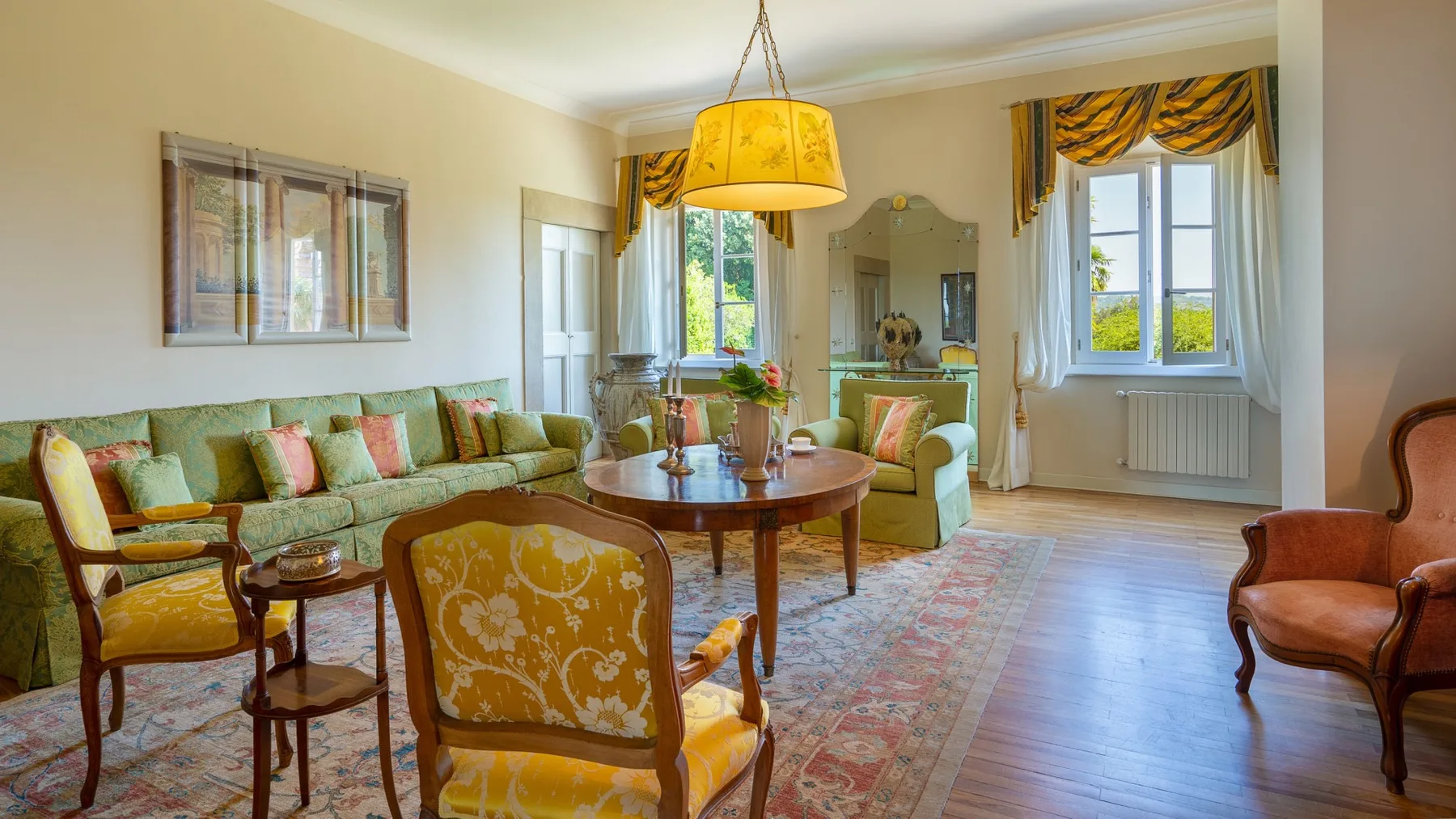 A living room with seating arranged around a wooden coffee table.