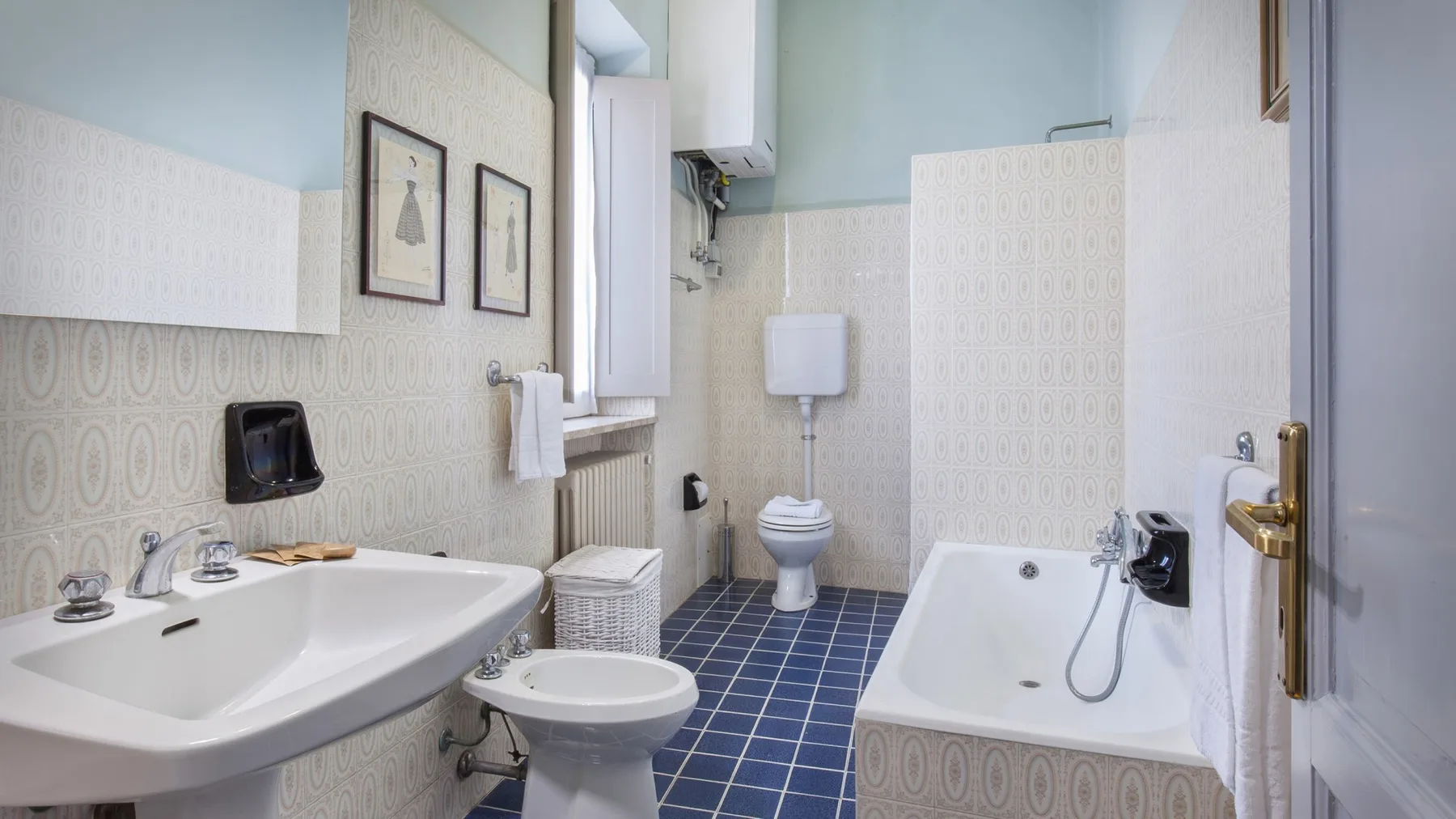 A tiled bathroom with a sink, toilet, and bathtub.