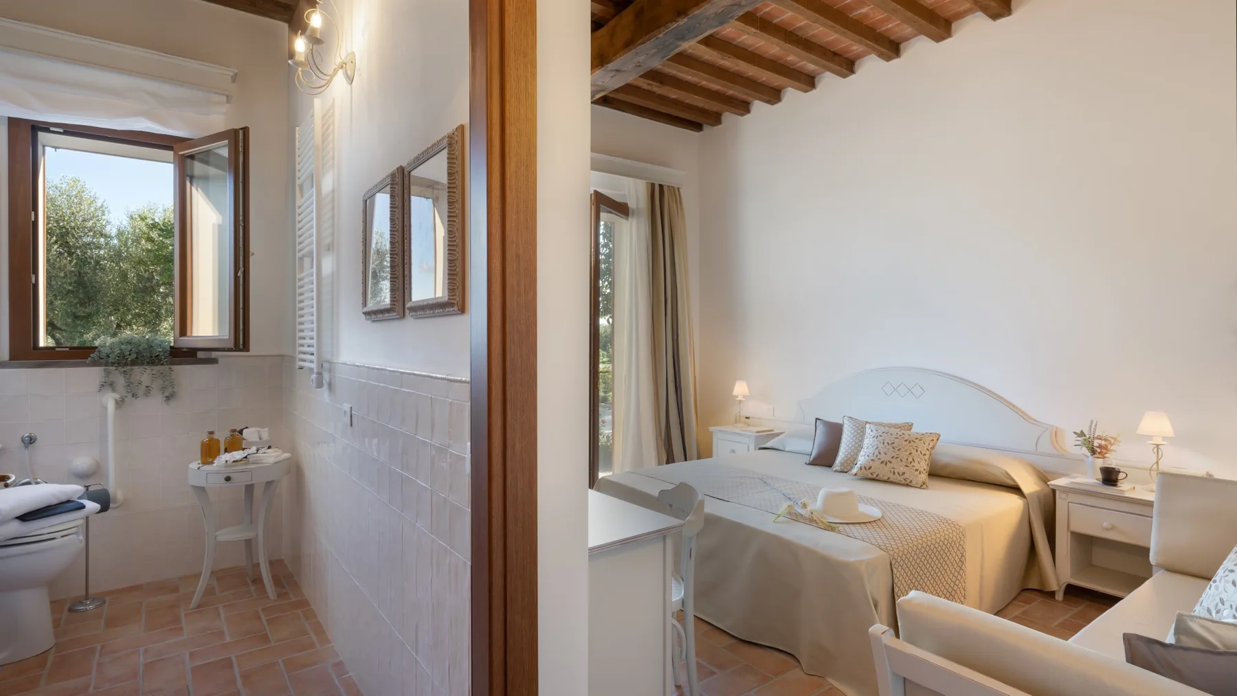 A bedroom with a bed and an adjoining bathroom visible through the doorway.