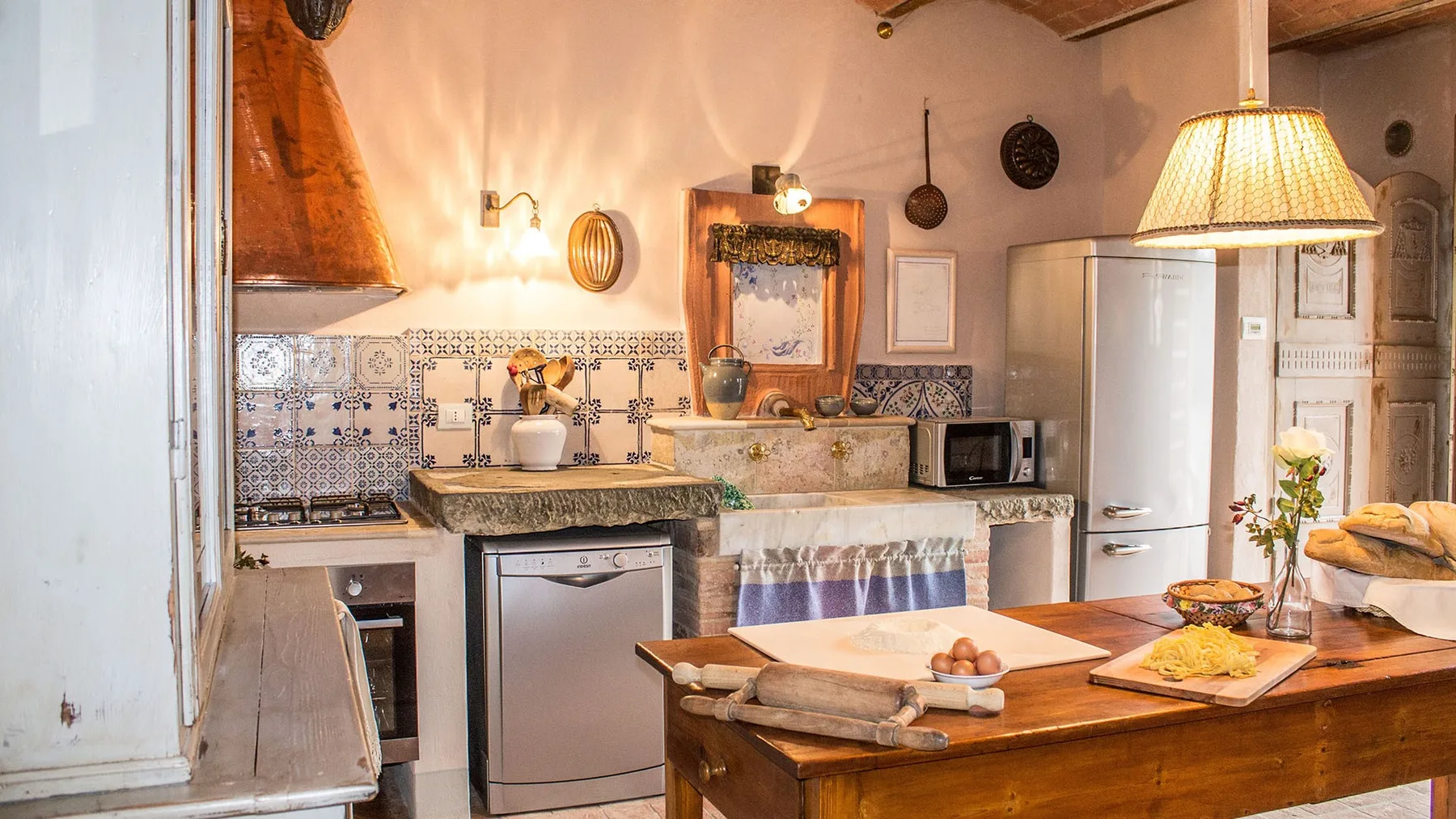 A rustic kitchen with patterned tile backsplash and a wooden island.