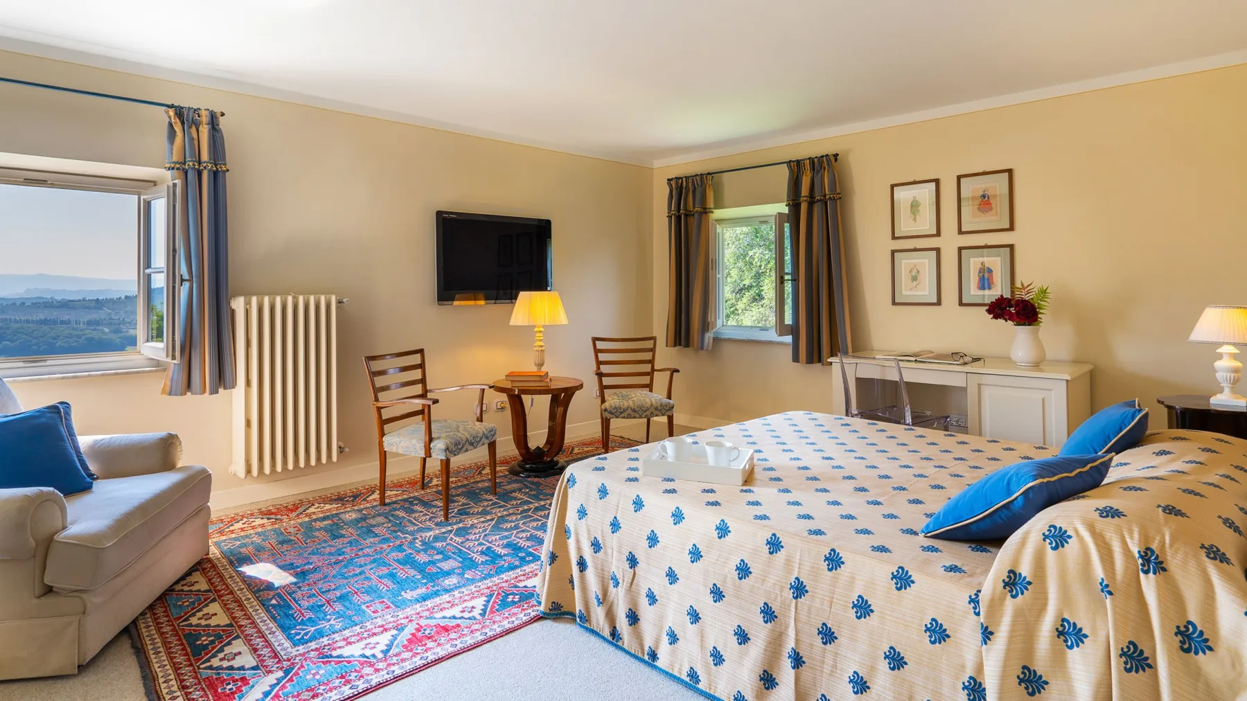 Un dormitorio con una cama grande, ropa de cama estampada y una alfombra colorida.