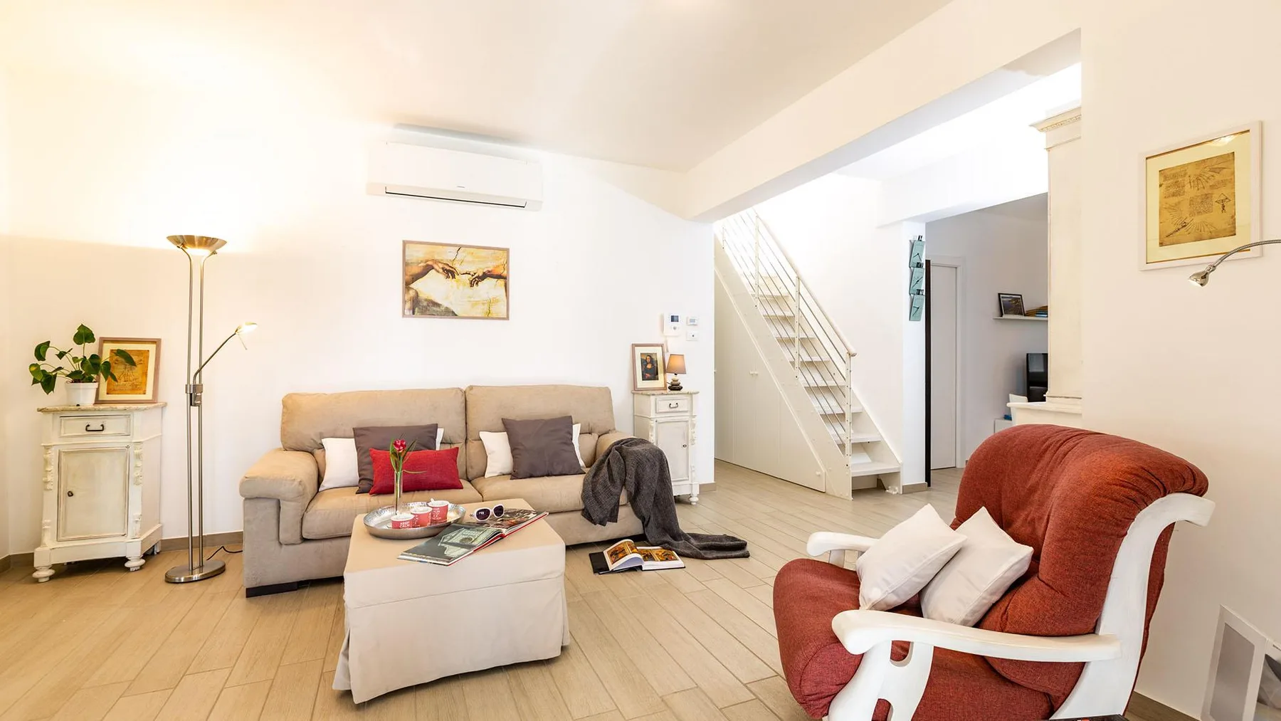 A bright living room with a sofa, coffee table, and armchair.