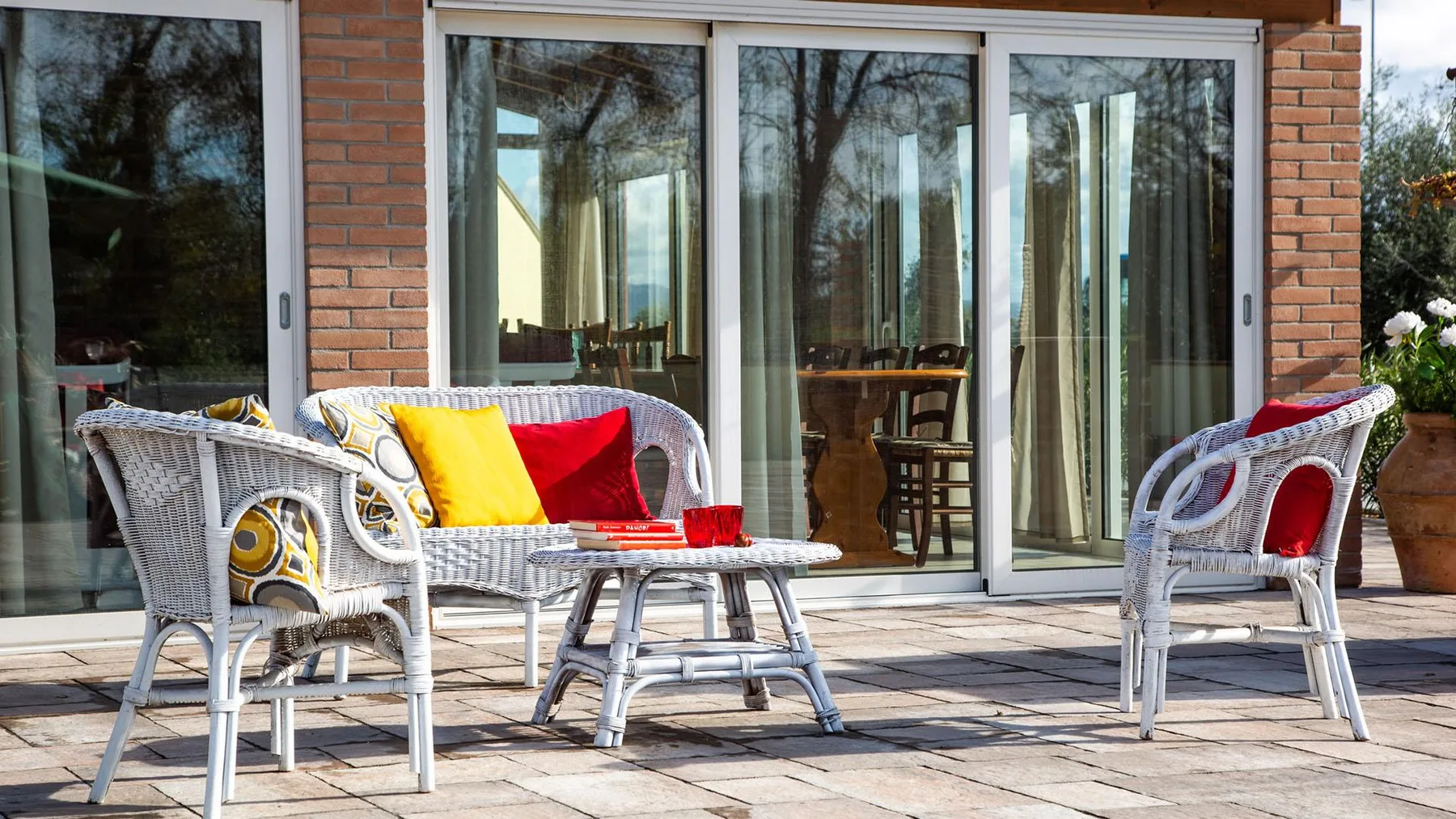 An outdoor patio seating area with cushioned chairs and a small table.