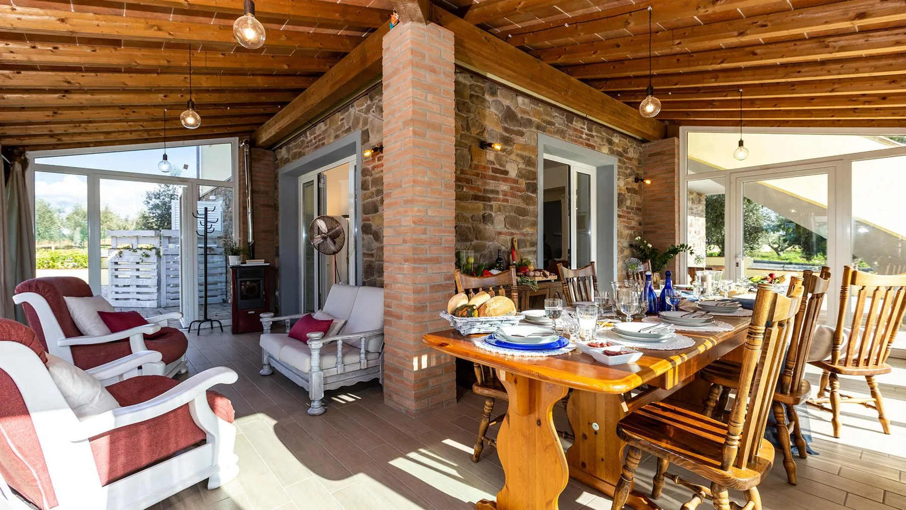 A dining area with a set table beside a bright living area.