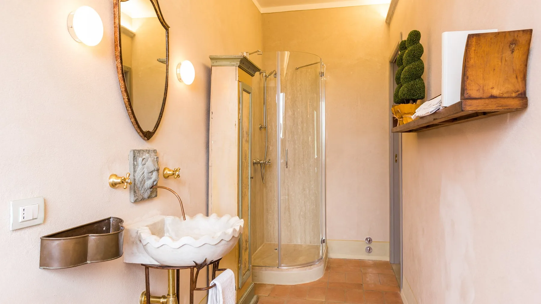 A bright bathroom with a glass shower and a decorative vessel sink.