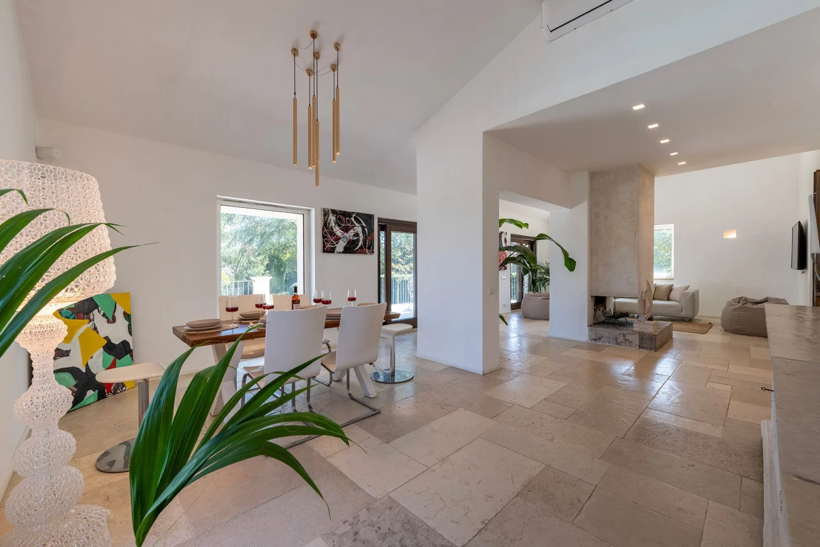 An open-plan living and dining area with a dining table and seating.