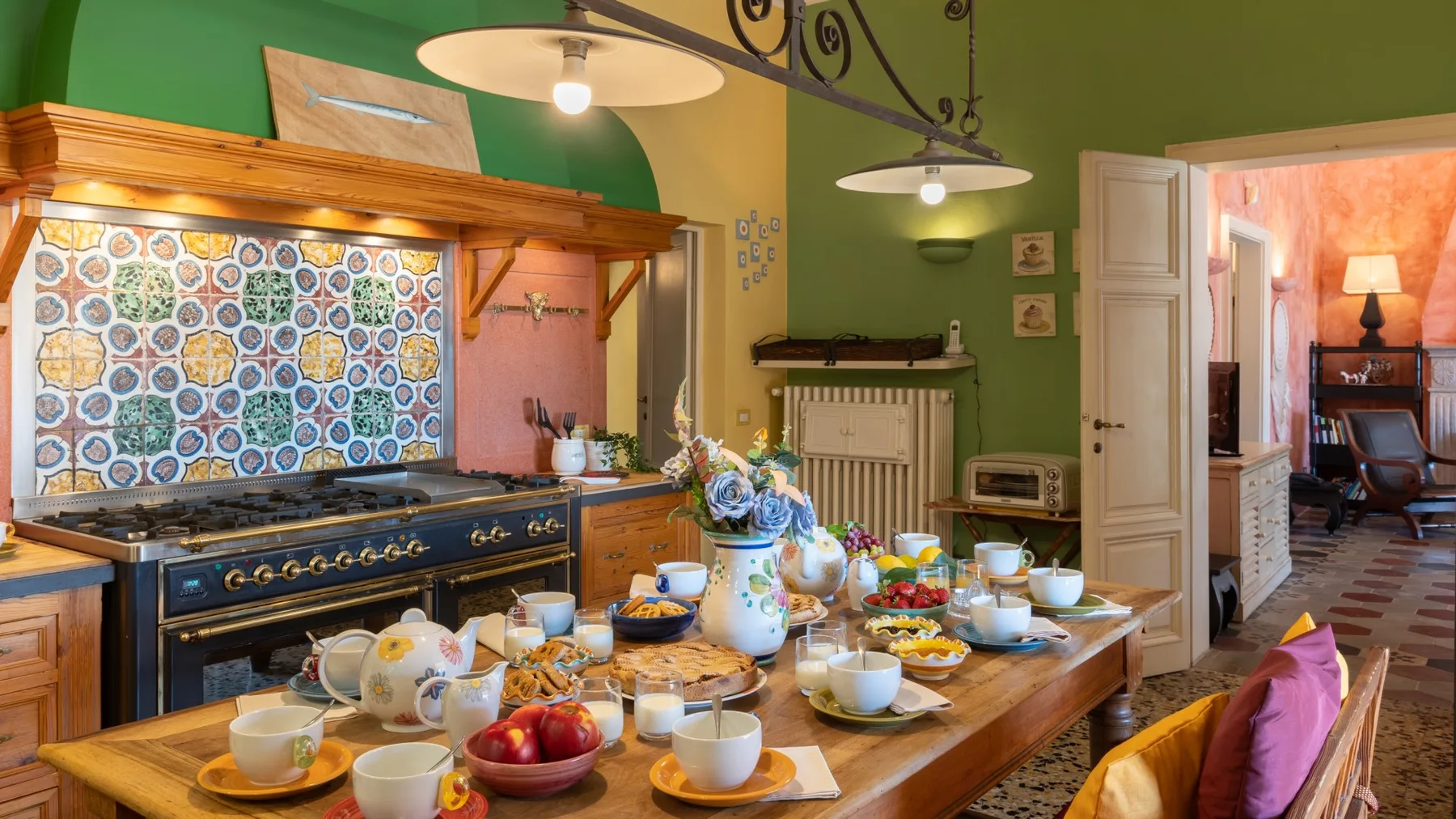 A colorful kitchen and dining area, with a table set for breakfast.
