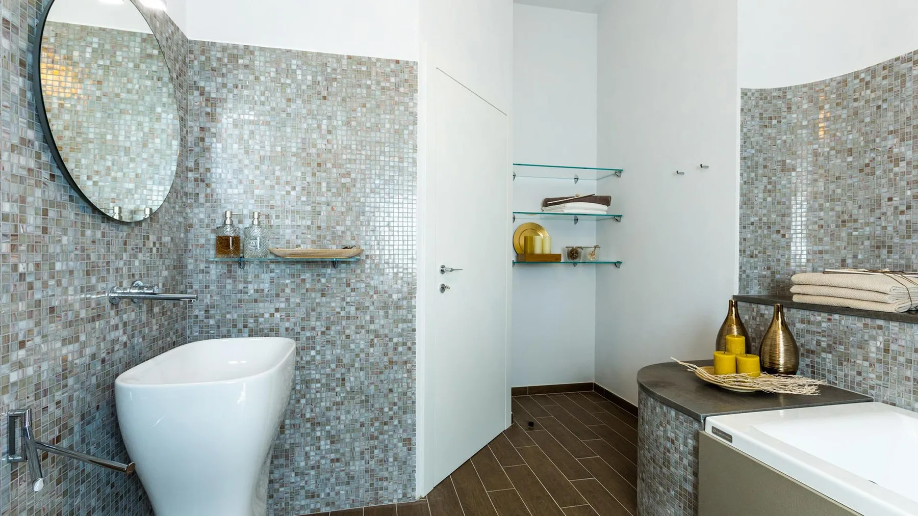 A tiled bathroom with a vessel sink, open shelves, and a bathtub.
