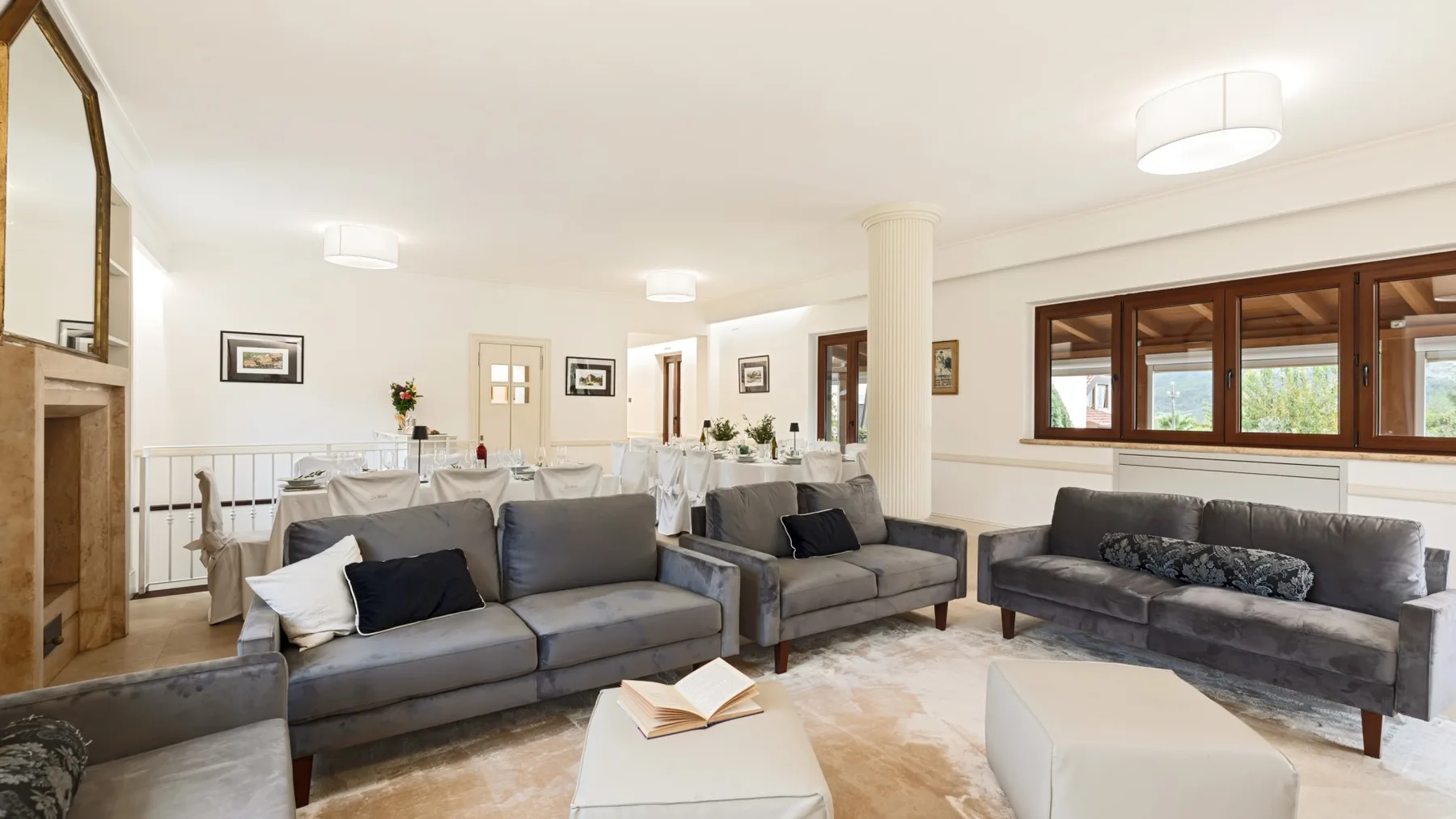 A bright living room with gray seating and a low white coffee table.
