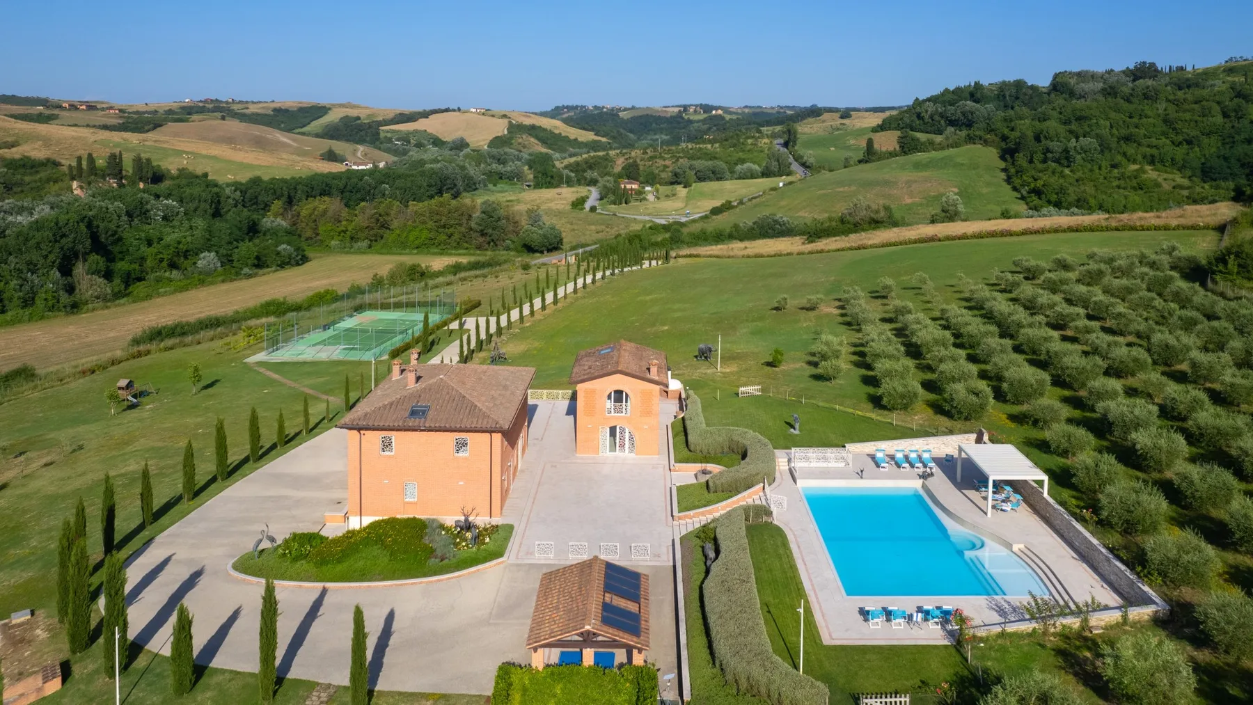Aerial view of a rural property with a swimming pool and surrounding fields.