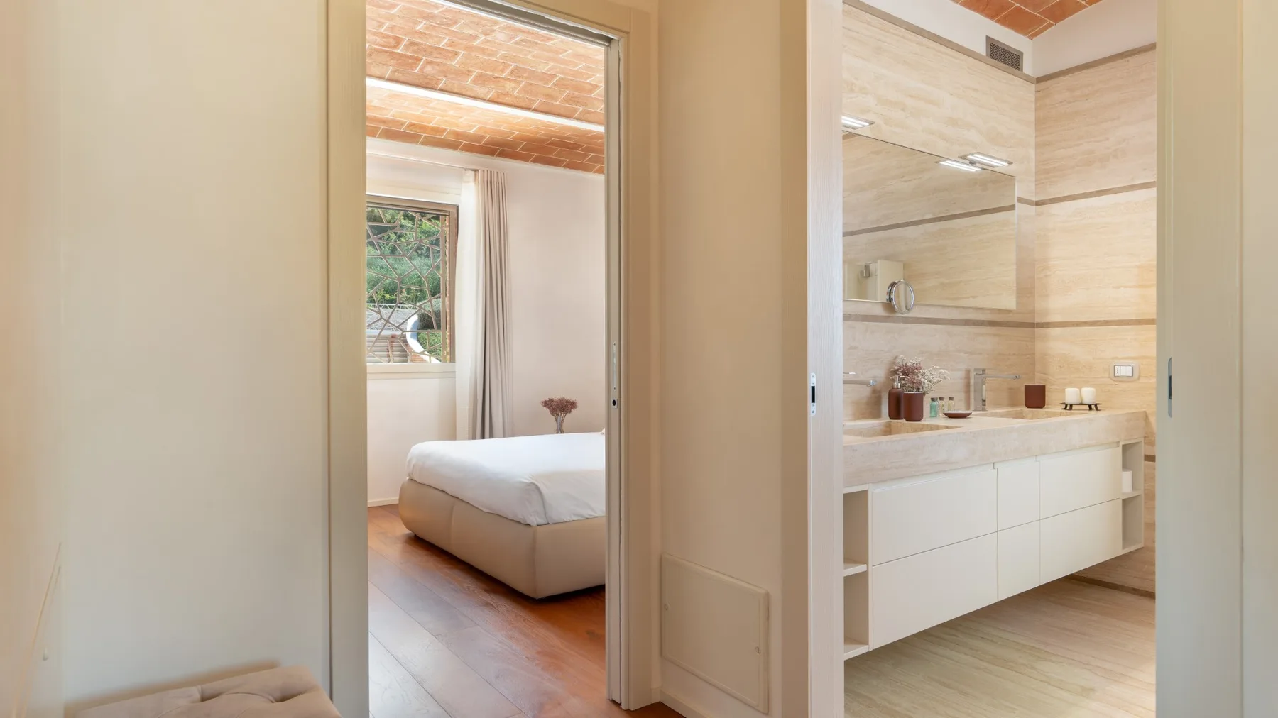 A bedroom and bathroom are visible through adjacent open doorways.