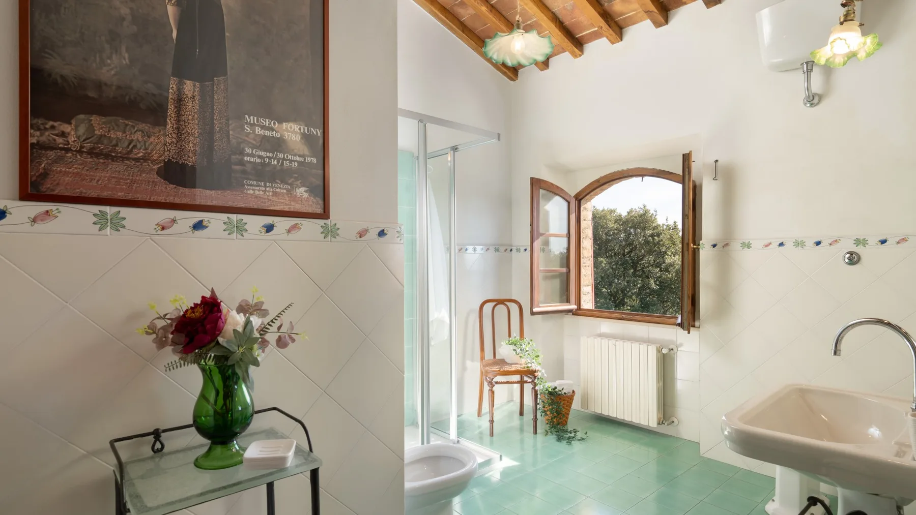 A bright bathroom with a window, sink, and tiled walls.