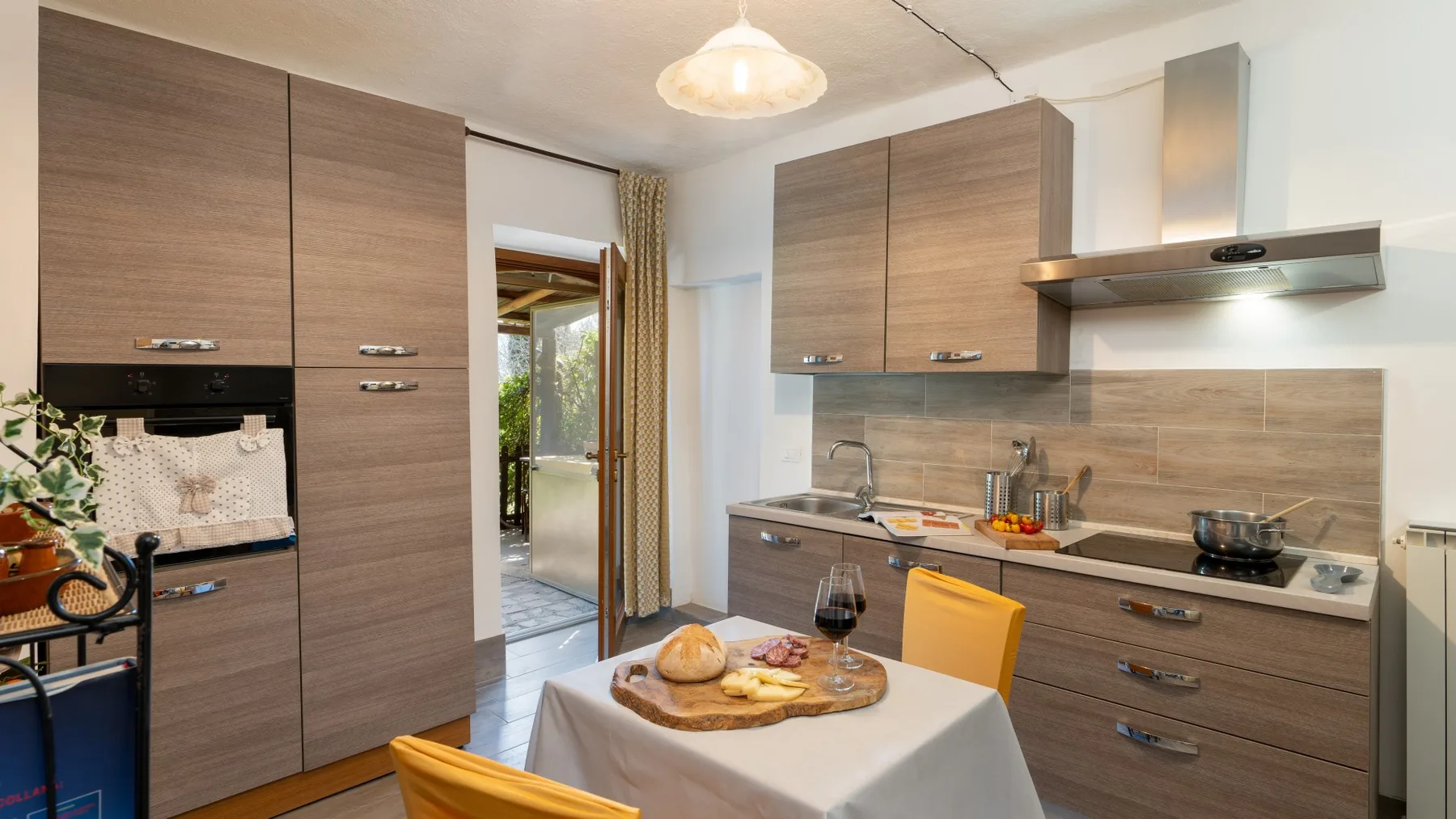 A kitchen and dining area with wood cabinetry, a countertop, and a set table.