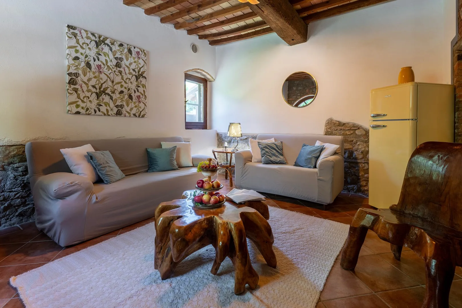 A living room with seating arranged around a low wooden coffee table.