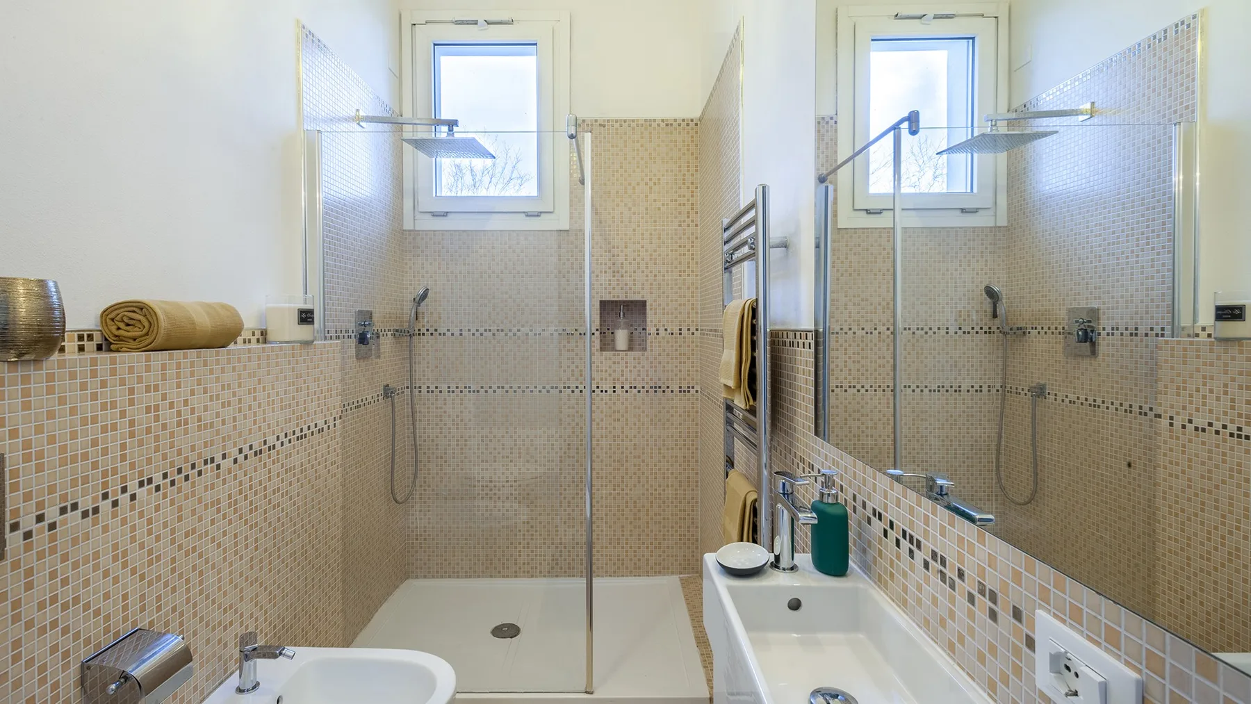 A tiled bathroom with a shower, bathtub, and window.