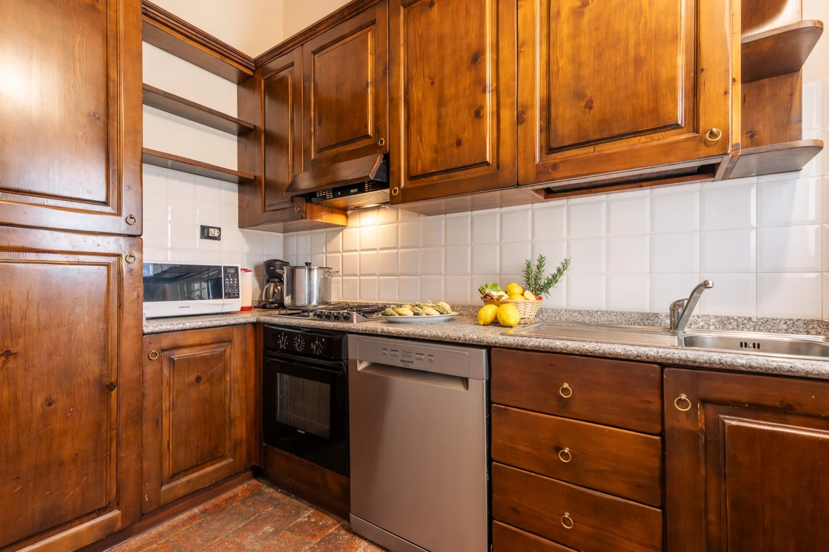 A kitchen with wooden cabinets, a countertop, and a sink.