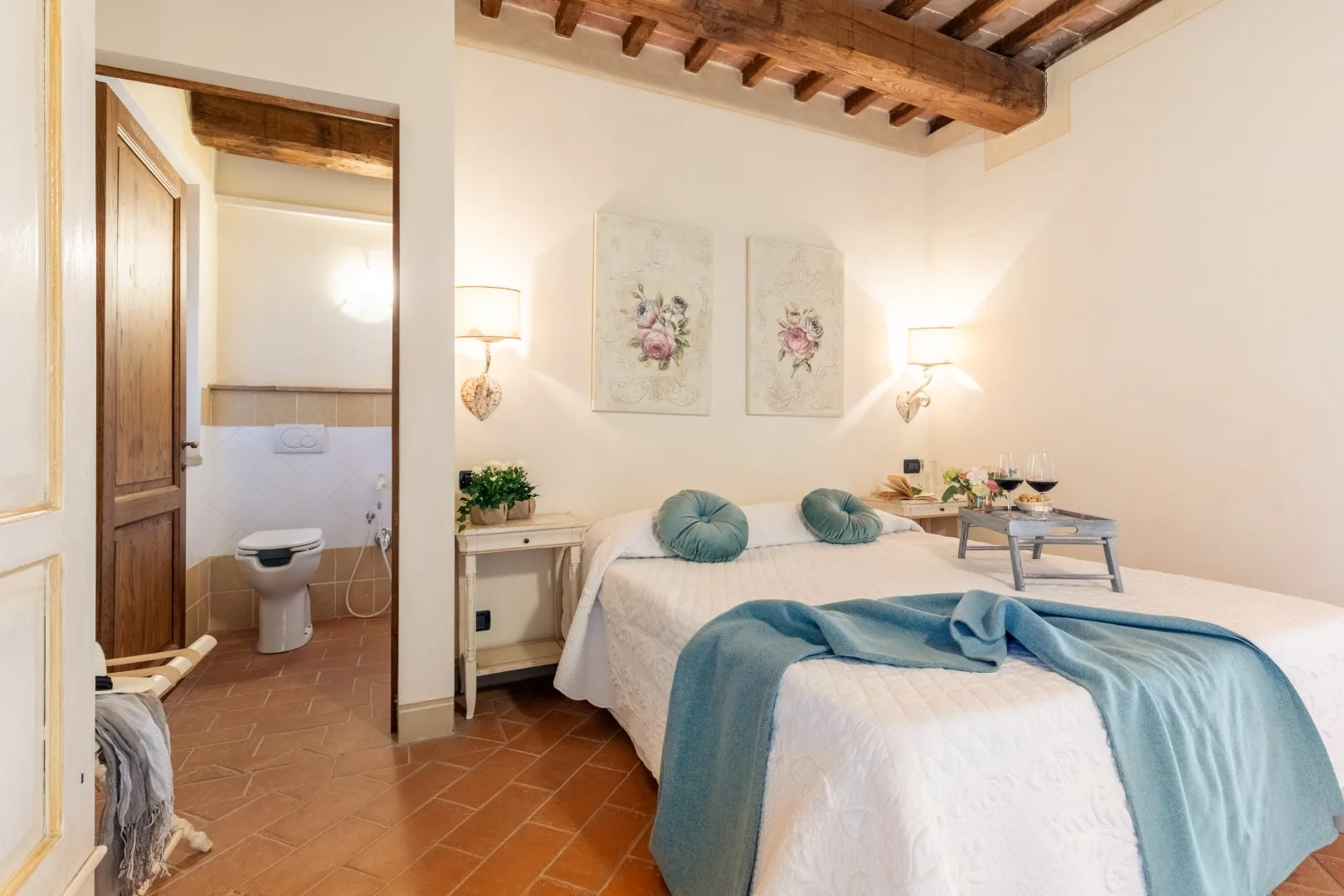 A bedroom with a bed and an open doorway to a bathroom.