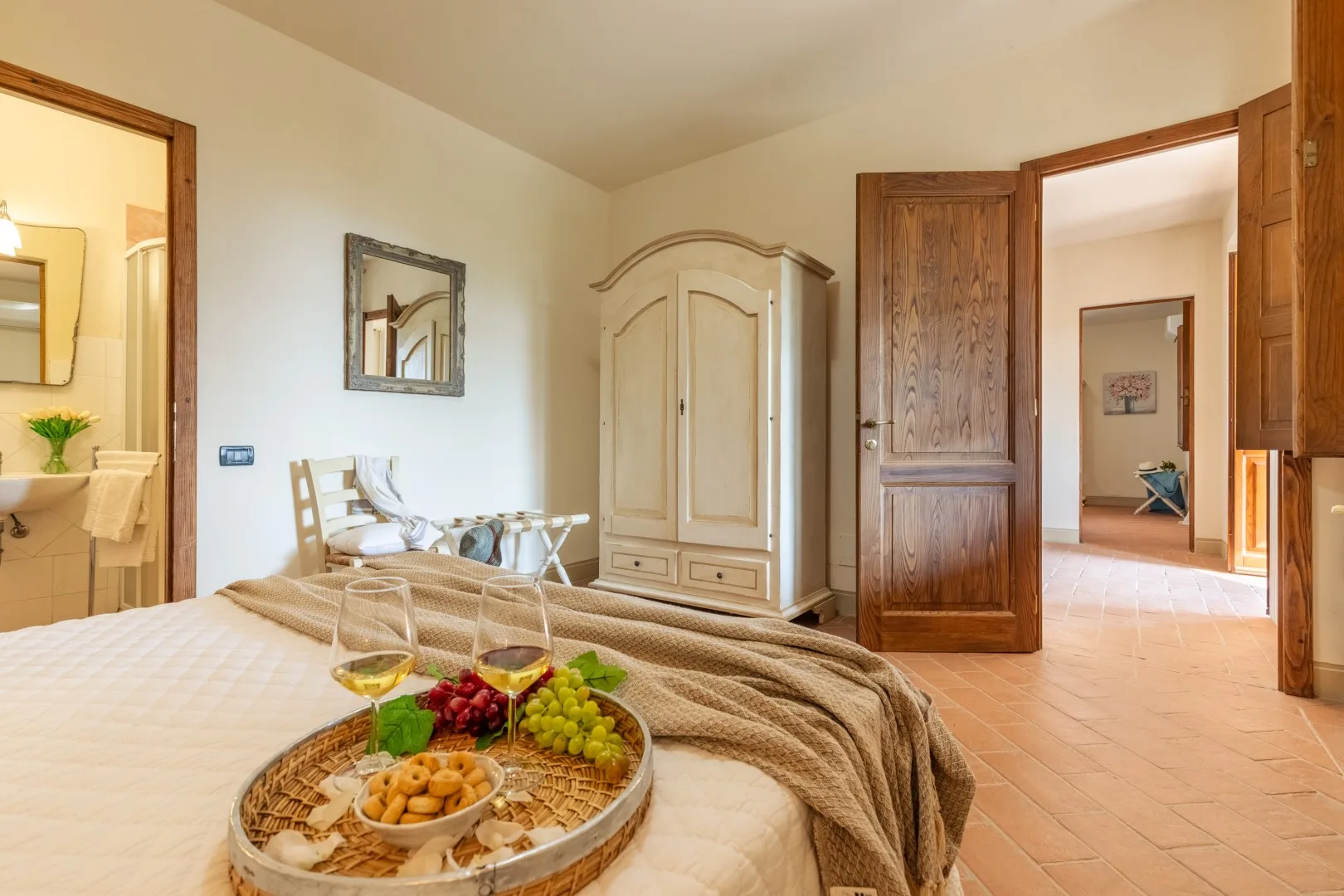 A bedroom with a bed, a wardrobe, and an open doorway.