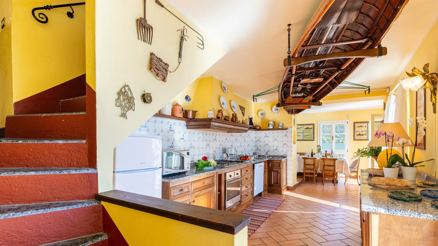 A bright kitchen with wooden cabinets, a tiled backsplash, and a dining area.