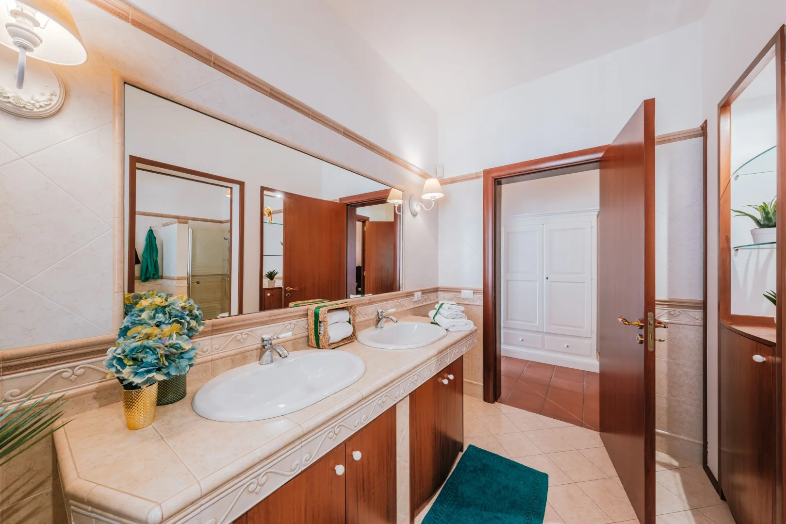 A bathroom vanity with two sinks and a large wall mirror.