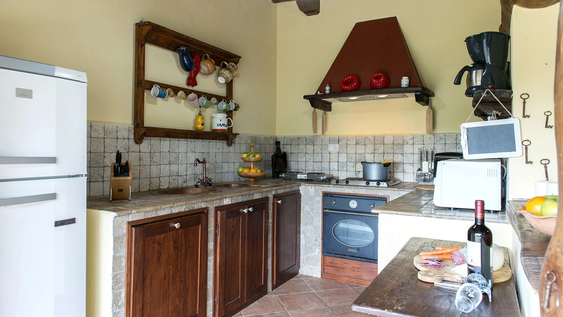 A kitchen with wooden cabinets, tiled walls, and a counter.