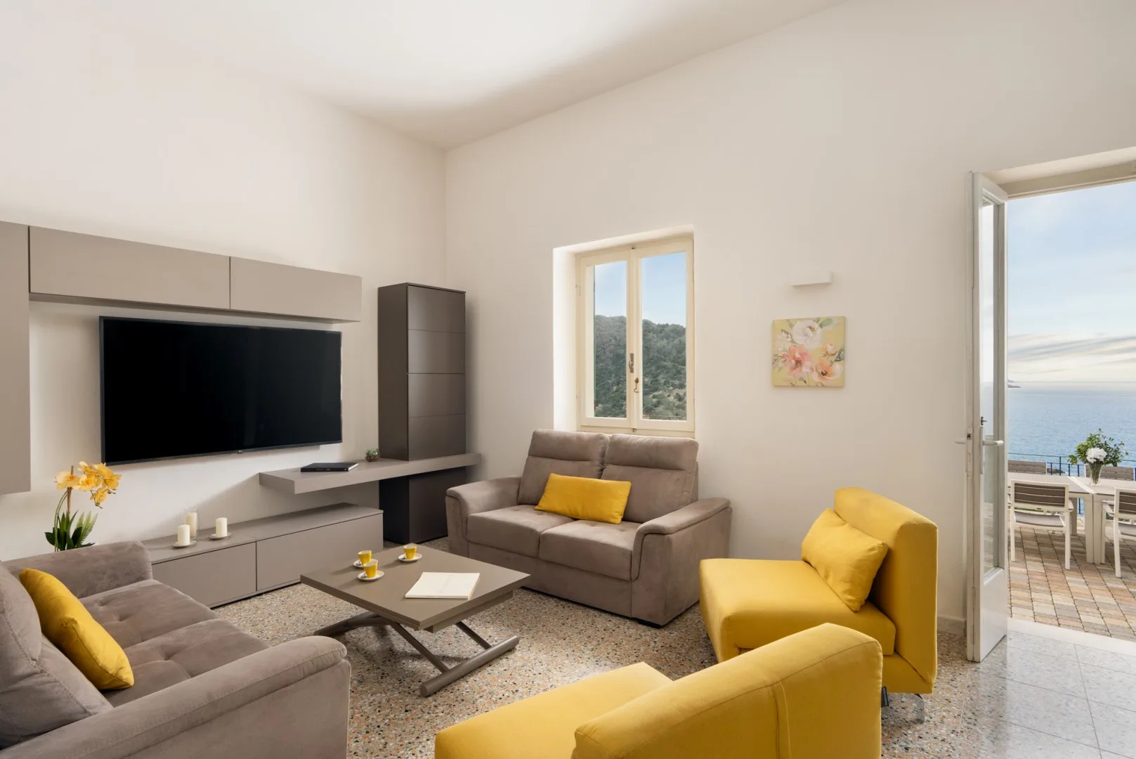 A living room with a television, seating, and a coffee table.