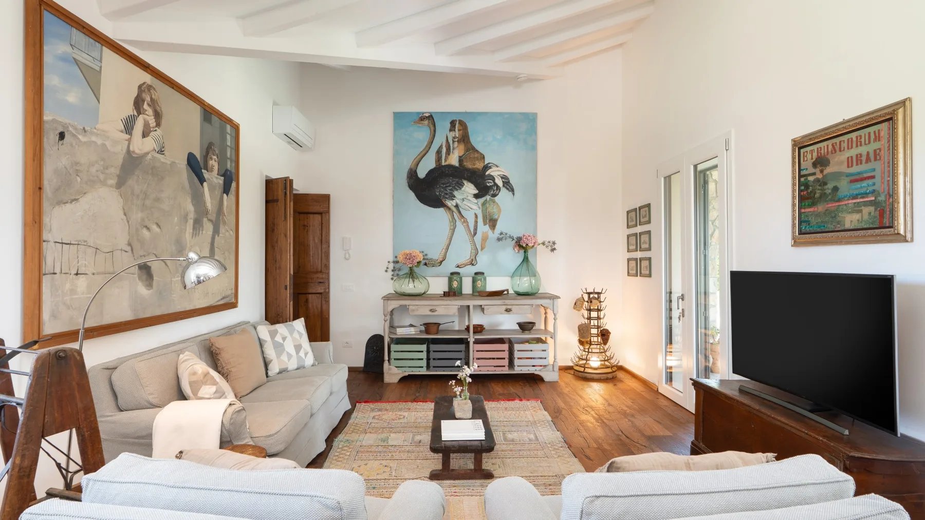 A living room with seating arranged around a coffee table and television.