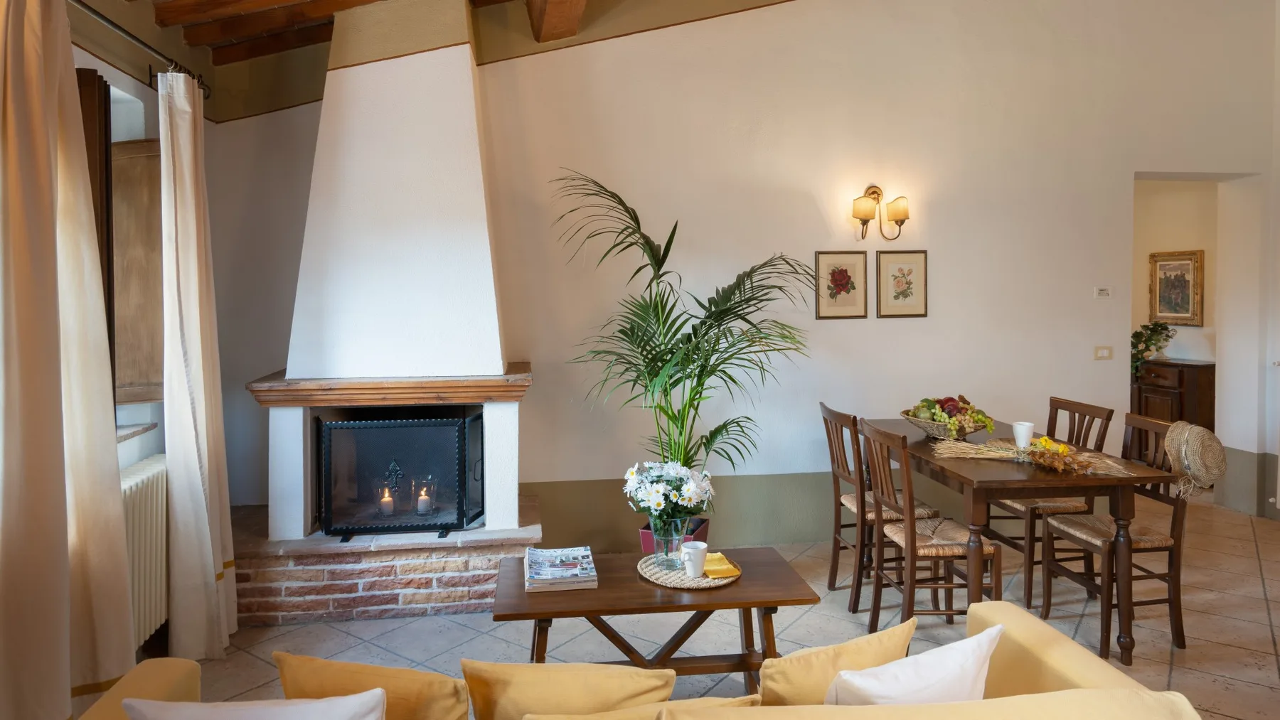 Una zona de comedor y estar con una mesa de madera, sillas y una chimenea.