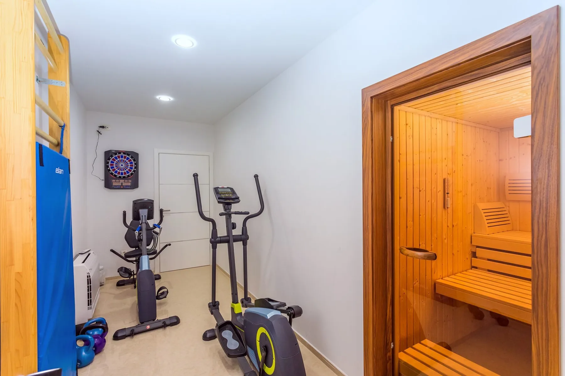 A small exercise room with stationary bikes and a wooden sauna.