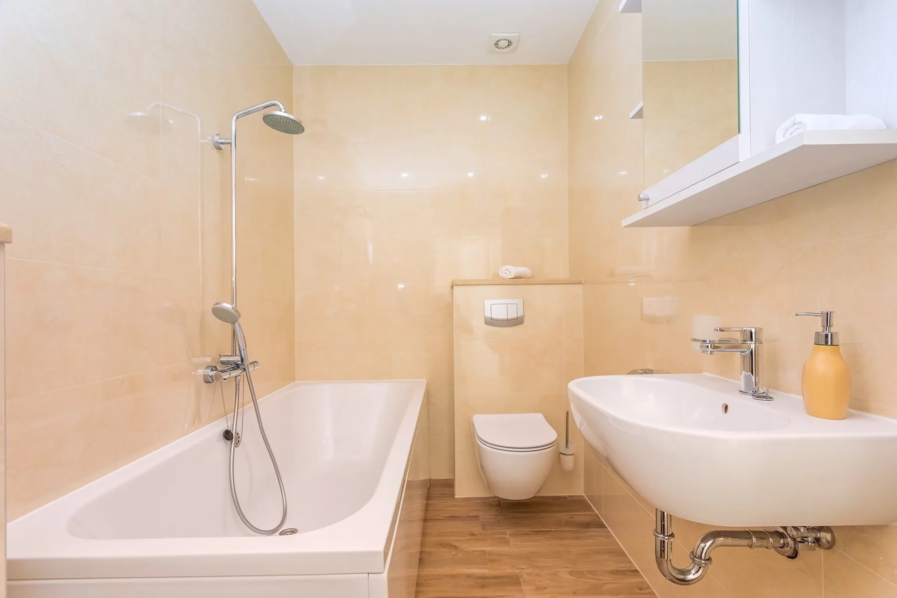 A bathroom with a bathtub, shower, toilet, and sink.