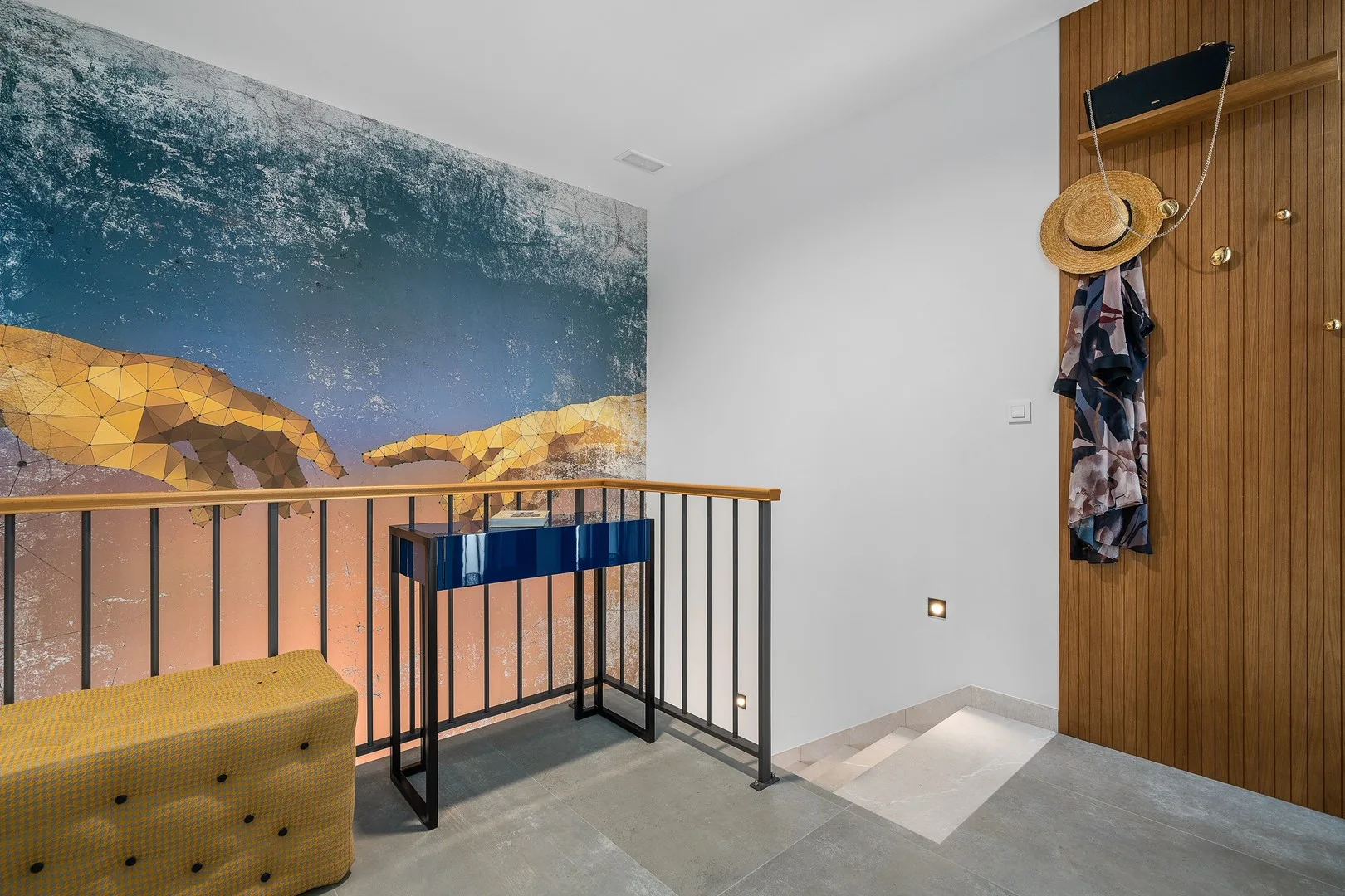 A room with a railing and a large ocean-themed wall mural.